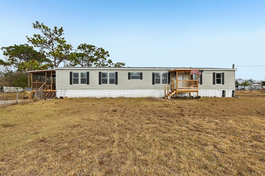 Offering interest rate buy-down or closing cost credit through preferred lender! Set on nearly one acre of land, this spacious 4-bedroom, 2-bathroom double-wide manufactured home offers approximately 2,280 sq. ft. of comfortable living space with no HOA and no CDD fees.

The primary suite serves as a private retreat featuring an en-suite bath with dual sinks, a garden tub, separate shower, built-in storage, and a walk-in closet. The split-bedroom floor plan enhances privacy, with three additional bedrooms located off the family room. This versatile area can function as a game room, secondary living space or home office.

The kitchen features generous counter space, abundant cabinetry, a breakfast nook and a formal dining room. The open-concept layout flows into the main living areas, creating an ideal space for everyday living and entertaining. The living room is highlighted by a cozy wood-burning fireplace, adding warmth and character to the home.

Fully fenced front and backyard along with a storage shed. The expansive lot offers room for outdoor activities, gardening, or other permitted uses. Conveniently located with quick access to St. Cloud and Melbourne, this home offers peaceful surroundings while remaining close to shopping, dining, and major roadways. Nearby amenities include a community park with a playground, basketball court, walking trails, and picnic pavilions.

This property combines space, comfort, and potential—ready for you to make it your own.