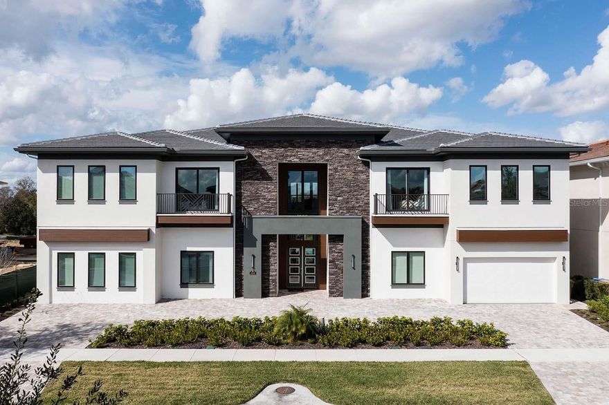Set along the 18th hole of the Jack Nicklaus Signature Golf Course in The Bear’s Den at Reunion Resort, this 10-bedroom, 12-bathroom estate was built for those who expect their home to perform as beautifully as it presents. With over 9,000 square feet of interior space and retractable glass walls that open to a fully equipped outdoor living area, this home moves seamlessly from slow mornings to full-scale entertaining. Inside, a striking glass wine display anchors the main level, leading into a dramatic dining space. Behind it: a dual-kitchen setup—one for service, one for show—ready for private chefs or casual dinners alike. The floor plan is expansive, but never overwhelming. Open, but with smart separation where it counts. Multiple living areas offer space to spread out. A full arcade, two-tier home theater, and custom-themed bunk room bring the fun, while a private sauna, gym, and pool with spa overlook the fairway. Every detail evokes the feeling of a private resort. Built for connection, this home invites people to gather. It’s made for hosting large celebrations, enjoying quiet relaxation, and everything in between. Whether you're hosting for the holidays, bringing clients together for a retreat, or just escaping for a weekend with the people who matter, this home is built to hold it all—with comfort, control, and character in every square inch. Located within Reunion Resort, with a staffed gate, top-tier amenities, world-class golf, and dining. Just minutes from Orlando’s best, yet fully self-contained when you want it to be. Space to Host. Privacy to Recharge. A Home That Does Both—Effortlessly. In a Short Term Rental Program with an inheritable booking calendar. Transferrable Reunion Resort Membership