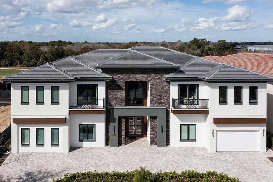 Set along the 18th hole of the Jack Nicklaus Signature Golf Course in The Bear’s Den at Reunion Resort, this 10-bedroom, 12-bathroom estate was built for those who expect their home to perform as beautifully as it presents. With over 9,000 square feet of interior space and retractable glass walls that open to a fully equipped outdoor living area, this home moves seamlessly from slow mornings to full-scale entertaining. Inside, a striking glass wine display anchors the main level, leading into a dramatic dining space. Behind it: a dual-kitchen setup—one for service, one for show—ready for private chefs or casual dinners alike. The floor plan is expansive, but never overwhelming. Open, but with smart separation where it counts. Multiple living areas offer space to spread out. A full arcade, two-tier home theater, and custom-themed bunk room bring the fun, while a private sauna, gym, and pool with spa overlook the fairway. Every detail evokes the feeling of a private resort. Built for connection, this home invites people to gather. It’s made for hosting large celebrations, enjoying quiet relaxation, and everything in between. Whether you're hosting for the holidays, bringing clients together for a retreat, or just escaping for a weekend with the people who matter, this home is built to hold it all—with comfort, control, and character in every square inch. Located within Reunion Resort, with a staffed gate, top-tier amenities, world-class golf, and dining. Just minutes from Orlando’s best, yet fully self-contained when you want it to be. Space to Host. Privacy to Recharge. A Home That Does Both—Effortlessly. In a Short Term Rental Program with an inheritable booking calendar. Transferrable Reunion Resort Membership