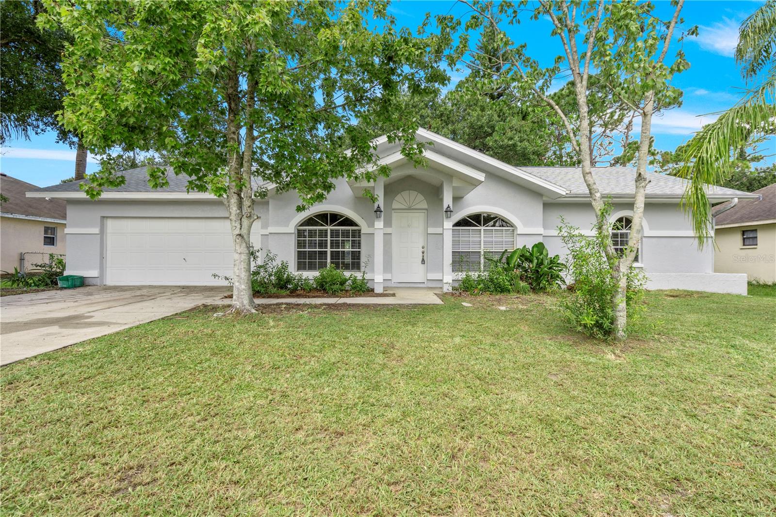 This stunningly renovated 3-bedroom, 2-bathroom home features a spacious, open-concept floor plan with vaulted ceilings and new, luxury vinyl flooring. New AC (2025) and ROOF (2023). The chef’s dream kitchen has a massive island, new white shaker cabinets, and stainless steel appliances. The bright and airy living area is enhanced by a large arch window. The master bathroom is a true retreat with dual sinks, a freestanding tub, and a separate shower. All bathrooms have been completely remodeled. Outside, a fully fenced backyard and a screened-in patio provide perfect spaces for relaxation. The home also includes a dedicated laundry room.