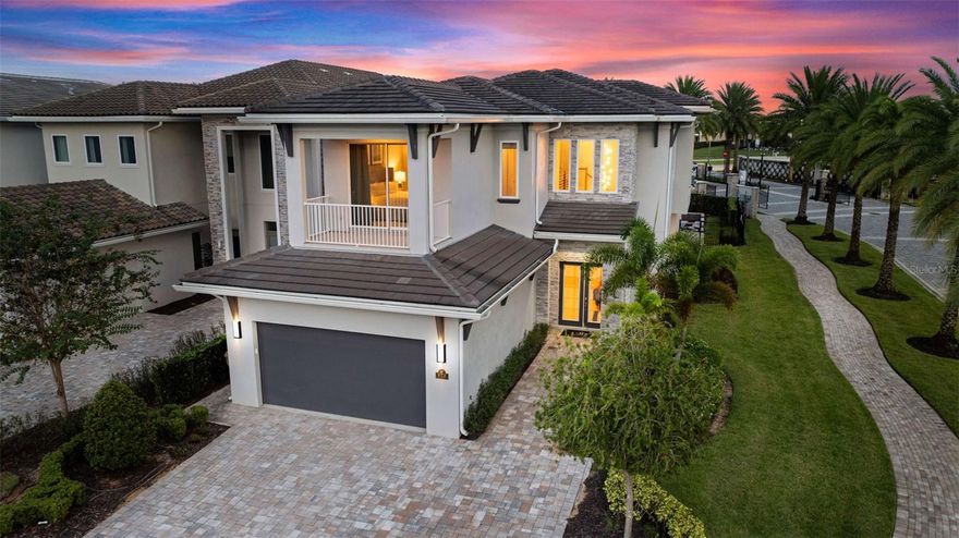 Located within the exclusive Bear’s Den community at Reunion Resort, this luxury Montecito floor plan residence offers an exceptional combination of refined design and strong vacation rental appeal. Positioned on a desirable corner lot, the home showcases elegant architectural details, a paver driveway, manicured landscaping, and a scenic palm-lined approach. Private balconies and covered outdoor living areas create a seamless indoor-outdoor lifestyle within one of Reunion’s most exclusive enclaves. Built in 2020 and offered fully furnished, the home features 4,485 square feet of living space with 5 bedrooms, 5 full baths, and 1 half bath. The well-designed layout includes two bedrooms on the main level and three upstairs, each with access to a full bathroom, making it ideal for accommodating larger groups and maximizing rental flexibility. The open-concept kitchen, dining, and living areas provide an inviting central gathering space designed to enhance guest experience and rental performance. The chef’s kitchen featuring a gas cooktop with exterior-vented hood, built-in oven and microwave, refrigerator, dishwasher, and an expansive center island with generous seating. Crisp cabinetry, abundant counter space, and an open layout create a functional yet sophisticated environment that resonates with luxury renters. Designed for entertainment, the home includes a game room and a private theater with tiered seating, projection screen, ceiling-mounted projector, and surround sound, delivering an authentic in-home cinema experience. The resort-style backyard offers a private oasis featuring a heated custom pool and raised heated spa, expansive paver deck, lush privacy landscaping, and dramatic fire bowls. A covered lanai with summer kitchen and outdoor TV provides the ideal setting for outdoor dining and entertaining, while the second-story balcony overlooks the pool and offers a tranquil retreat for day-to-night enjoyment. Additional features include a two-car garage and a transferable Reunion Club membership. The property is ideally located just steps from the Traditions Clubhouse and within walking distance to Reunion’s Water Park. Reunion Resort amenities include three championship golf courses, a multi-acre water park, resort-style pools, fitness centers, on-site dining, tennis and pickleball courts, concierge services, and a gated luxury resort setting. Located minutes from Walt Disney World, Reunion Resort is one of Central Florida’s most desirable luxury vacation communities, known for strong rental demand and repeat guests. Whether as a turnkey income-producing investment or a high-end second home, this Bear’s Den residence offers an exceptional combination of location, layout, amenities, and long-term appeal.