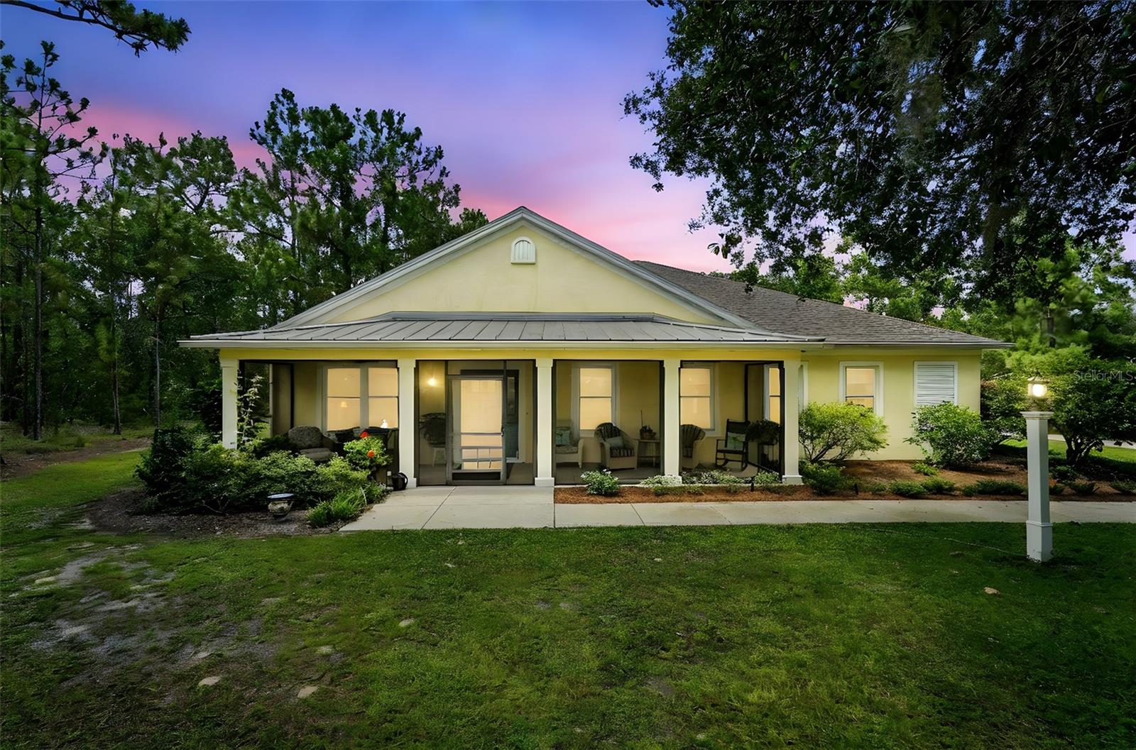 Nestled on a beautifully landscaped one-acre lot in the peaceful, golf cart-friendly community of Oak Hill, this custom-built block and stucco home offers a perfect blend of quality craftsmanship, thoughtful design, and timeless comfort.
Built in 2015, the home features 3 bedrooms, 2.5 bathrooms, and 2,006 square feet of living space under air, with a total of 3,149 square feet including two spacious screened porches—one in the front and one in the rear—each with ceiling fans to create a seamless transition between indoor and outdoor living.
Inside, the open-concept layout showcases 9-foot volume ceilings and energy-efficient spray foam insulation in the trusses, making the home exceptionally comfortable and easy to heat and cool. Designed with accessibility in mind, the floorplan is step-free throughout (except for a single low step at the front door) and includes 36-inch wide doors, curbless showers, and open, barrier-free spaces that are ideal for all stages of life.
The chef’s kitchen is the heart of the home, featuring solid wood custom cabinetry with pull-out trays, extra-deep 12-inch upper cabinets, a massive 8-foot island, a built-in china cabinet, a gas oven and range, and a spacious walk-in pantry. The adjoining laundry room includes a closet for additional storage and convenience.
The primary suite is a peaceful retreat, highlighted by elegant tray ceilings, oversized walk-in closets, and a luxurious en suite bath with a comfort-height vanity and toilet, as well as a walk-in, curbless shower. Each room in the home is outfitted with a ceiling fan, and the interiors are finished in soft, neutral tones that complement any décor style.
For those who love outdoor living, the rear lanai is a showstopper, featuring an insulated roof and a brand-new summer kitchen installed in July 2025—perfect for entertaining friends and family. The home also includes a gas-powered on-demand water heater, an oversized two-car garage with hurricane-rated doors, and quality double-pane windows from Window World with a transferable lifetime warranty.
A detached 24’ x 36’ workshop offers flexible space for woodworking, hobbies, or extra storage. The property also includes a five-zone irrigation system for easy lawn maintenance.
Situated along the horse trail of the Preserve with no rear neighbors, this home provides privacy, tranquility, and direct access to nature. Its location offers convenient access to Tampa, Orlando, and Gainesville, making it an ideal choice for those seeking quiet country living with city amenities just a short drive away.
Schedule your private showing TODAY!
