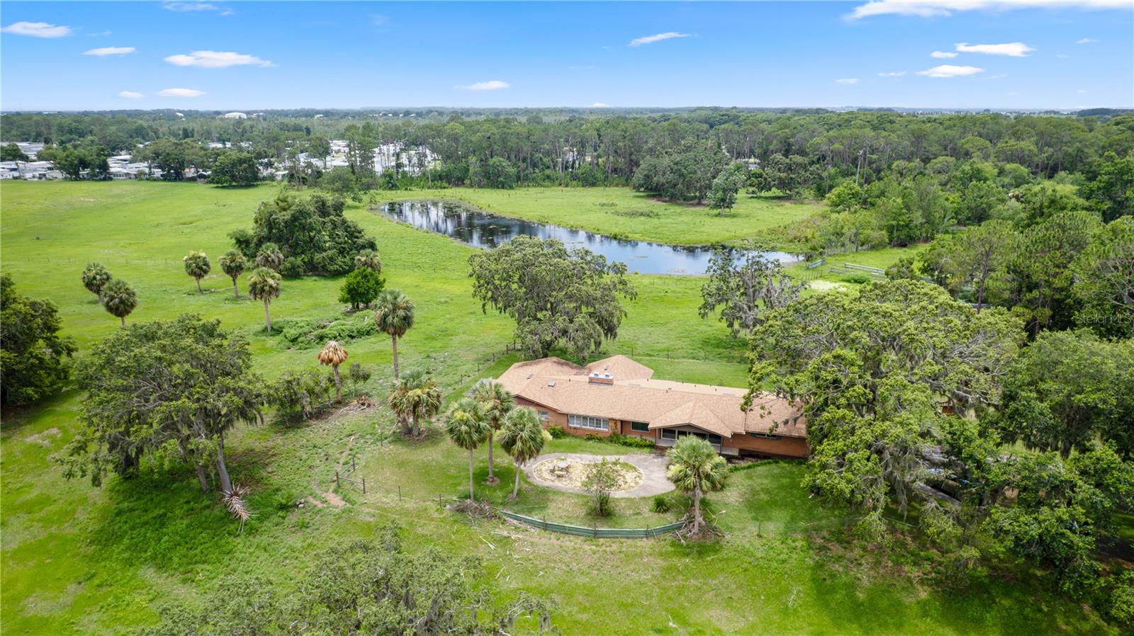 Spectacular 42-Acre Ranch Estate in Tavares, Florida
Welcome to your dream homestead. A tree-lined gated entrance sets the tone as you approach this sprawling property of lush, fenced pastureland highlighted with majestic oaks surrounding a picturesque pond. This exceptional ranch offers everything you need for country living with comfort, functionality, and breathtaking views.
The main residence has 3 bedrooms and 3 baths. Home features vaulted ceilings accenting wide open living spaces blending modern convenience with rustic charm. Plenty of windows and glass doors allowing you to enjoy the awesome views of the estate.
This would make a fantastic family compound with the potential of multiple homesites!
Designed for the serious rancher or equestrian enthusiast, the property includes:
• A barn and equipment barn for all your tools and gear
• bunkhouse ideal for unique private space or entertainment venue
• Horse stalls, cow pens, and a roping arena ready for action
• Secure, fenced pastures for easy livestock rotation and grazing
Whether you’re looking to operate a full-time cattle or horse operation or simply enjoy the peace of rural Florida living, this property checks every box. Privacy, functionality, and natural beauty all come together in this one-of-a-kind ranch.
All of this, just minutes from shopping, dining and entertainment.
Don’t miss the opportunity to own a piece of paradise. The town of Tavares, often referred to as “America’s Seaplane City,” is a vibrant and scenic community in central Florida. Located in Lake County, Tavares offers a high quality of life, combining small-town charm with modern amenities. Here are some of the key benefits of living in This Property is in the city of Tavares which is situated on the shores of Lake Dora and part of the Harris Chain of Lakes, Tavares is a paradise for water enthusiasts. Boating, fishing, kayaking, and seaplane activities are central to the lifestyle The city boasts scenic parks, trails, and abundant opportunities to enjoy the outdoors. Tavares provides easy access to nearby cities like Orlando, Mount Dora, and Leesburg and Major attractions, such as Walt Disney World and Universal Studios, are less than an hour away. The downtown area is a hub of activity, featuring waterfront restaurants, shops, and entertainment venues. Regular events, festivals, and live music performances keep the community engaged and lively. Golf courses, hiking trails, and recreational facilities are abundant in the area
friendly community, Tavares combines the best of small-town living with the conveniences of being near major metropolitan areas