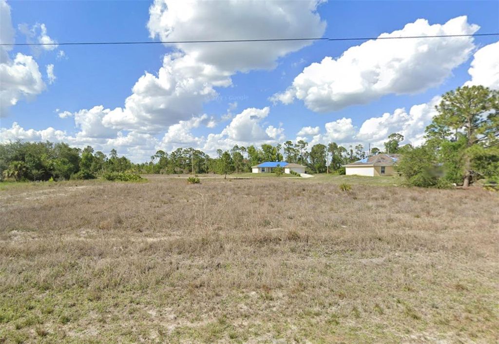 Photo of 1241 Delores Street E, Lehigh Acres, FL 33974 (MLS # O6312134)