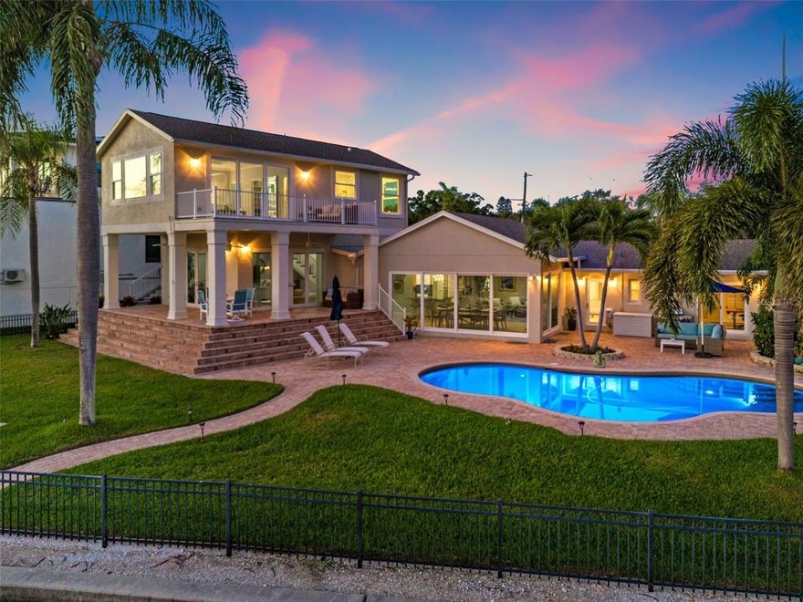 Luxurious WATERFRONT living in the heart of Northeast St Pete! This beautiful pool home is nestled along the picturesque Smacks Bayou in NE St Petersburg, offering an unparalleled lifestyle of luxury and tranquility. Boasting an impressive 144 feet of waterfront on a generously wide waterway, this residence allows you to soak in the beauty of both sunrise and sunset right from your backyard every day. 
This home underwent a 3-year TOTAL renovation/transformation with an investment of nearly 1 MILLION dollars in upgrades and high-end finishes. You will notice the attention to detail in every room. As you enter you are greeted right away with a bright open-air space and wall-to-wall glistening water views! The impact sliding doors open fully to give you that dreamy indoor/outdoor resort-style living feel. The open floor plan allows for water views from almost every room in the home. The kitchen is a chef's dream at the heart of the home with high-end finishes and appliances. There is a butler's pantry for additional storage perfect for when entertaining guests. Step up to a very spacious secondary living area that is the perfect flex space, and could be used for casual living for the family, a yoga studio, or a home office.. endless possibilities! This area also has amazing water views with sliding doors that lead to your outdoor oasis! This lot is expansive and has plenty of green space for the kids and dogs to run and play! The crown jewel of this home is the stunning and spacious 2nd-floor primary suite, featuring a private balcony that provides breathtaking panoramic water views. The spa-like en suite bath is a retreat in itself, complete with a luxurious tub, separate shower, and a spacious walk-in closet and laundry area. This sanctuary offers a perfect vantage point to unwind and savor the serenity of waterfront living. There are 3 other spacious bedrooms on the main living level with one being an en suite with water views and sliding doors to the backyard. Outdoor living at its very best in the resort-like backyard, where an inviting pool, hot tub, covered patio, and a private dock with lift await. Whether you're taking a refreshing dip in the pool, indulging in the hot tub, or setting sail from your private dock, every day feels like a vacation at home. The layout of this residence is designed for seamless entertaining, featuring two distinct living areas that provide ample space for hosting gatherings and creating cherished memories with family and friends. Situated near Crisp Park in NE St Petersburg, this home offers easy access to the vibrant downtown St Petersburg scene where you will enjoy waterfront parks, sidewalk cafes, museums, and more! Boaters will appreciate the convenience of being just minutes away from Tampa Bay by boat. Enjoy the ease of daily living with shopping options like Publix, Trader Joe's, and Whole Foods within walking distance. For those who travel frequently, Tampa International Airport (TIA) is a mere 30-minute drive away. Indulge in the epitome of waterfront living with this meticulously curated residence. Every detail has been thoughtfully considered, making this home a true gem in the heart of St Petersburg's coveted waterfront community. Welcome to a life of unparalleled luxury, comfort, convenience, and breathtaking natural beauty. You MUST SEE this home to truly appreciate everything it has to offer!