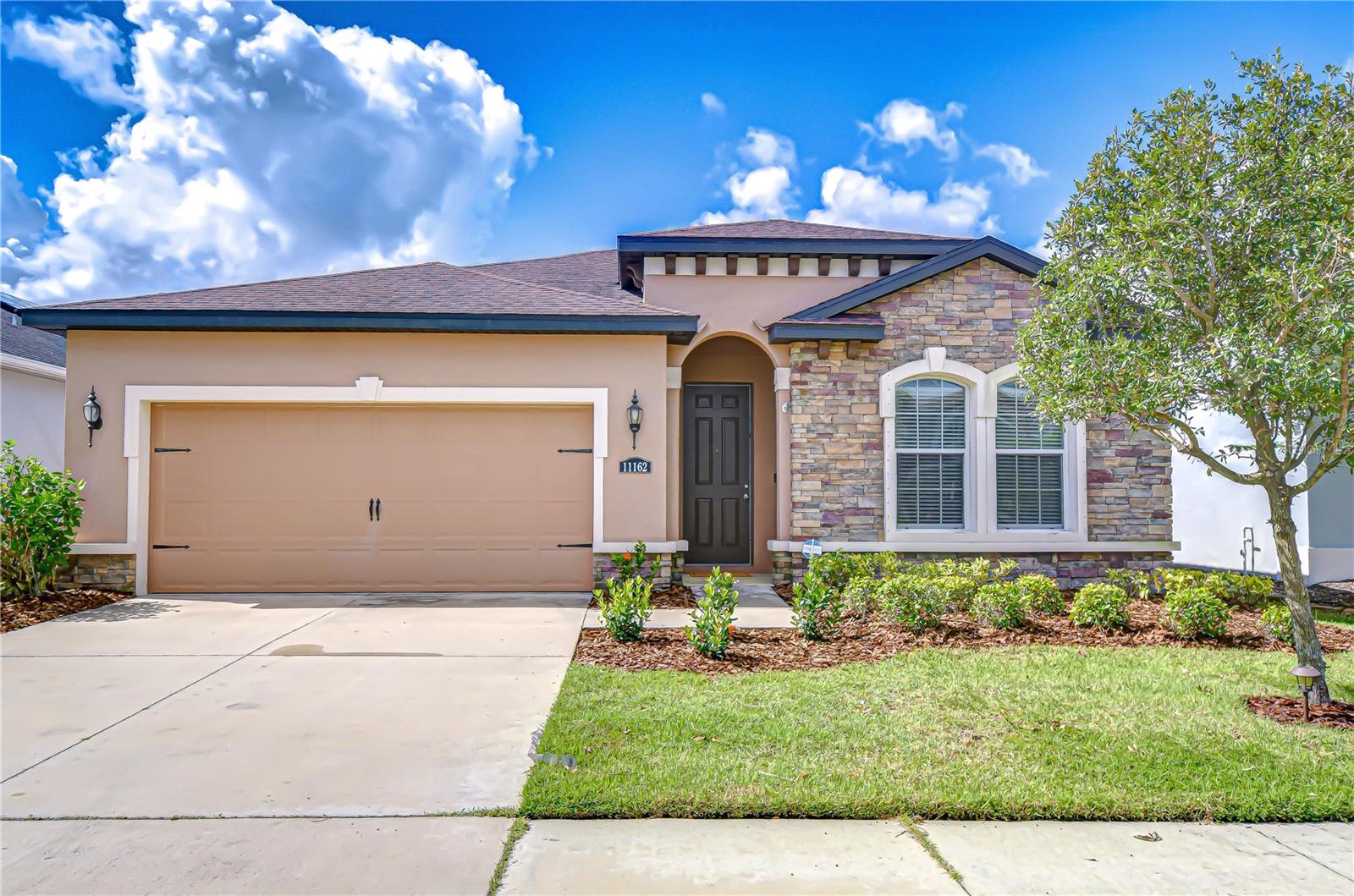 Welcome to this stunning 4-bedroom, 3-bathroom home in the highly sought-after Lucaya Lake community! From the moment you arrive, you’ll be captivated by the beautiful curb appeal—complete with stacked stone accents and lush tropical landscaping that warmly welcome you home. Step inside to discover an open-concept floor plan filled with natural light. The spacious living and dining areas create a warm, inviting atmosphere—perfect for both everyday living and entertaining. At the heart of the home, the kitchen shines with granite countertops, stainless appliances, including a gas stove, abundant prep and storage space, and a large island with breakfast bar seating. The generous primary suite offers a walk-in closet and a spa-like en suite with double vanity, glass-enclosed walk-in shower, and an extra-deep soaking tub—perfect for relaxation. The tri-split floor plan provides flexibility, with three additional bedrooms: two connected by a Jack & Jill bath, and the fourth tucked away with its own full bathroom. Enjoy the outdoors year-round from the screened lanai overlooking the fully fenced backyard with no rear neighbors—ideal for both privacy and play. A community playground is also within walking distance. Living in Lucaya Lake means enjoying unmatched resort-style amenities: a sparkling pool with zero-entry play area and lap lanes, splash pad, sandy beach area along the 78-acre lake, 24-hour fitness center, walking trails, playgrounds, a clubhouse for private events, plus canoeing, kayaking, and paddleboarding on the lake. Perfectly located, this home offers easy access to top-rated schools, shopping, dining, medical facilities, and major highways, with Florida’s best beaches just a short drive away. This home beautifully blends style, comfort, and lifestyle—ready for you to make it yours! Copy and paste this link to tour the home virtually: my.matterport.com/show/?m=XMfX4oD2Gnb&mls=1