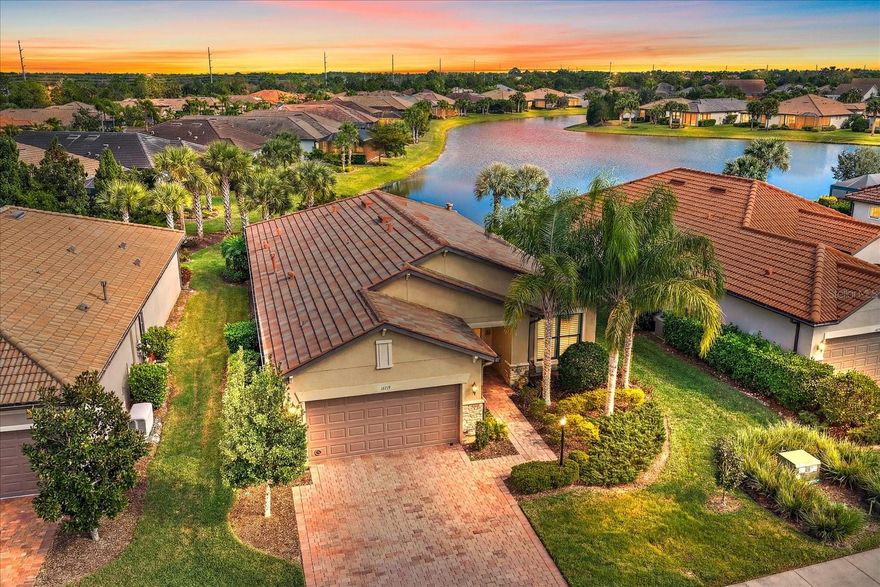 Live on vacation now! RESORT-STYLE LIVING begins today in this gorgeous MAINTENANCE-FREE home with SPECTACULAR pond views. 
METICULOUSLY MAINTAINED 2 Bed/2 Bath plus DEN *OPEN split floor plan with excellent natural light 

*CERAMIC PLANK FLOORING*PLANTATION SHUTTERS on all windows and sliders
*CROWN MOLDING 
* HURRICANE SHUTTERS
*Custom built-in air-conditioned WORKSHOP in 3rd of garage. This makes an awesome man cave! (Golf Cart will fit inside!)
*HUGE island in kitchen! Perfect for baking, preparing meals and entertaining! 
* GAS cooktop and UPGRADED stainless steel appliances
* PREMIUM CABINTRY*HUGE walk-in pantry
* TRAY CEILING in Primary bedroom
* ENSUITE with Soaking tub and separate shower.
* Laundry room nearby with cabinets and laundry tub 
* PORTABLE GENERATOR INCLUDED
* Extended screened lanai plumbed for outdoor kitchen
* Additional PAVED OUTDOOR PATIO for relaxing or gardening 
* Peaceful pond views and beautiful sunsets

DEL WEBB at Lakewood Ranch is a gated 55+ community designed for people who want more than just a home; they want a lifestyle! Here, every day feels like a vacation with resort-style amenities, social activities, and plenty of opportunities to stay active or simply relax.
* Resort Style Heated pool!
* Tennis Courts and Pickleball
* Bocce Ball
* Fitness Room

* Wonderful Restaurant and Bar! Great place to hang out with friends and meet new people.  
 The homes are thoughtfully crafted with low-maintenance living in mind, offering modern features, flexible layouts, and energy efficiency that make life easier. Surrounded by lush landscaping, sparkling lakes, and scenic walking trails, it’s a community that feels peaceful yet perfectly connected. Plus, you’re just minutes from shopping, dining, beaches, and the vibrant arts scene in Sarasota and Bradenton. This life is not a dress rehearsal, live on vacation NOW! *(IN ADDITION: This home offers an assumable VA loan with an interest rate under 3%, subject to lender/VA approval. The Buyer must qualify for this loan.)*