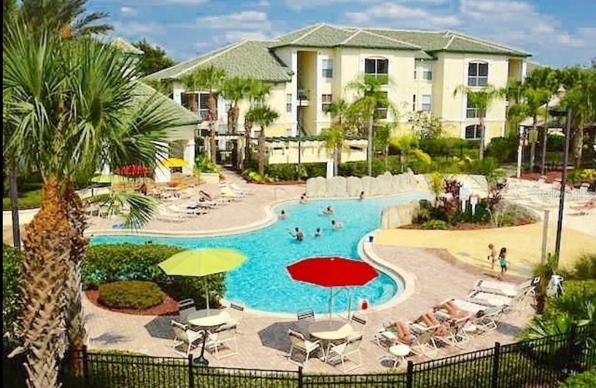 Live Just Minutes from the Magic- Fully Furnished! Welcome to this charming 1-bedroom, 1-bath condo located in a beautifully maintained gated resort-style community just moments from Orlando’s world-renowned theme parks and attractions. This inviting 636 sq ft unit features a spacious primary suite with an oversized walk-in closet and private in suite bath. Enjoy the convenience of in-unit laundry, vaulted ceilings, and stylish built-ins that add warmth and character to the living space. The community is loaded with luxury amenities, including a beach-entry pool, full fitness center, basketball, tennis, and volleyball courts, a golf cage, and a playground with a fun splash pad for the little ones.