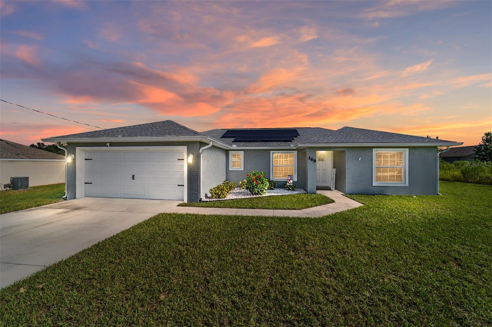 Discover this like-new, meticulously maintained 4-year-old home, packed with upgrades you'll love. Built with durable concrete block stucco in a convenient no-HOA community, this residence blends modern open-concept design with comfort and style.
Vaulted ceilings and luxury vinyl plank flooring create a bright and cohesive look throughout. The spacious living room flows seamlessly into the dining area and gourmet kitchen, perfect for entertaining or everyday living. The kitchen features soft-close cabinetry, stainless steel appliances and sleek granite countertops. A thoughtful split floor plan ensures privacy: the primary suite, accommodating a king-sized bed, includes a walk-in closet and ensuite bathroom. Two additional bedrooms share a well-appointed bathroom with a granite countertop vanity
Enjoy a NEW 12x10 screened-in patio, accessible via sliding glass doors from the dining area, ideal for relaxing or hosting guests.
EXCEPTIONALLY ENERGY EFFICIENT with *SOLAR PANELS*, sellers claim their average utility bills have been just $43 a month over the past year. Additional upgrades include a whole-house water softener and carbon filter for superior water quality from a private well, plus NEWLY installed gutters to protect the home from water damage Experience modern living with low maintenance and unmatched efficiency in this remarkable home.