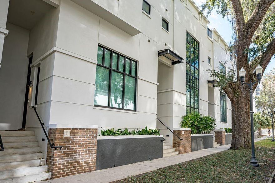Executive living right in the middle of Downtown Orlando. This  2 bedroom, 2.5 bath is a rare find, completely renovated: new paint, totally new kitchen; cabinets, stainless appliances, counter tops, sink, faucet... renovation includes new/updated bathrooms, flooring.  Living space is totally open floor plan, high ceilings… living room, dining room and kitchen and outdoor porch all on one floor. Utility closest  with new Washer/dryer is on the same floor as the bedrooms. This unit is stunning and just like new. Home has attached full 2 car garage plus storage, amazing large windows making everything light and bright. access to the rooftop provides you private outdoor space and a great view of the surrounding city. The community provides water/sewer and has a courtyard and park like setting to walk about. Walk to Lake Eola, local dining and shopping with Publix grocery, Dr Phillips Center, the Kia Center and the commuter Train are only a couple blocks.