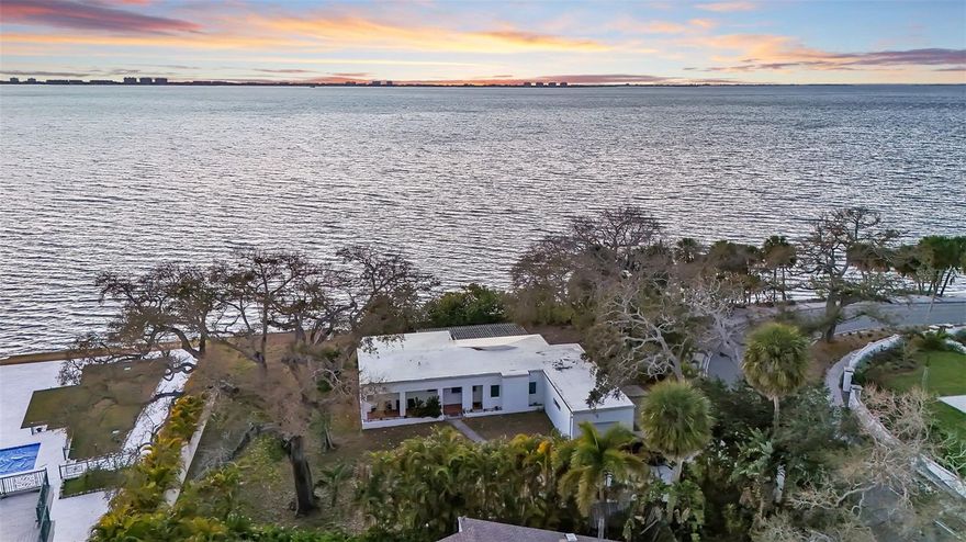 A rare chance to own a prime bayfront property in Sarasota’s highly desirable Sapphire Shores / Indian Beach neighborhood. Positioned on a 0.38-acre lot with 136 feet of direct Sarasota Bay frontage, 820 Indian Beach combines unobstructed water views, a generous homesite, and a location that continues to grow in demand. The property is currently an income producing rental property. The bayfront positioning provides wide water views, while mature trees and the depth of the lot offer privacy and shade.  A private path leads directly toward the water. Riprap spans the bayfront perimeter, securing the shoreline. Bayfront lots with this amount of frontage and lot size are increasingly limited within Sapphire Shores / Indian Beach, making the property an excellent candidate for a renovation, expansion, or entirely new construction. The homesite provides the scale and orientation to support a significant custom residence designed to maximize the views. The neighborhood remains one of Sarasota’s most established waterfront areas, known for its tree-lined streets, varied architecture, and close proximity to downtown Sarasota, St. Armand's Circle, shopping, dining, and Sarasota-Bradenton International Airport. 820 Indian Beach Road represents both an immediate waterfront lifestyle opportunity or investment and a highly compelling long-term property in a consistently sought-after location.