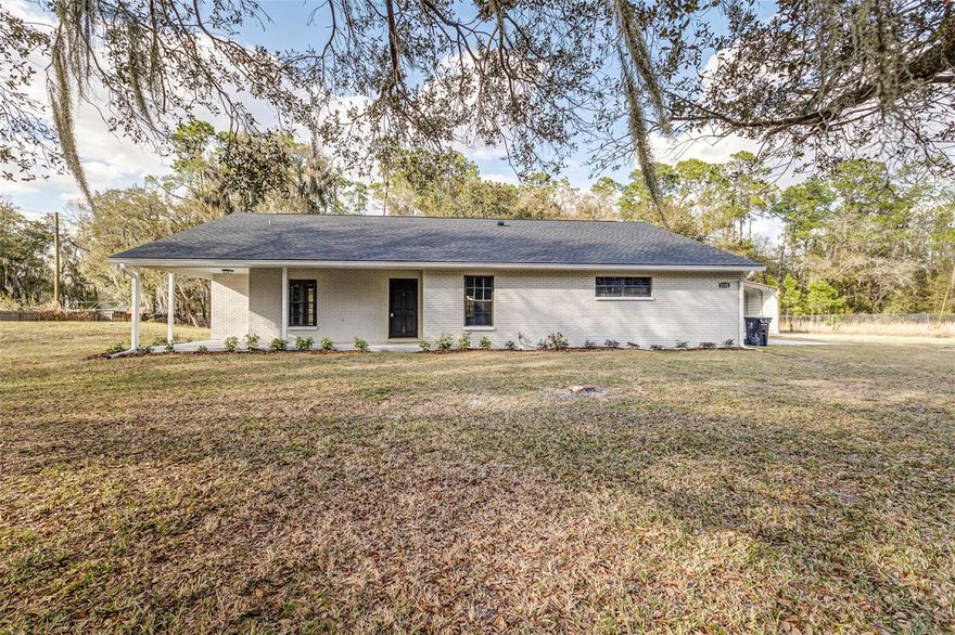 Enjoy the perfect blend of modern updates and peaceful country living in this newly renovated home situated on 1.4 fenced acres in North Lakeland - with NO HOA!
Inside, the home shines with thoughtful upgrades throughout. The brand-new kitchen features stainless steel appliances, quartz countertops, and all-new cabinetry, creating a fresh and functional heart of the home. Living areas showcase new luxury vinyl plank flooring, while bedrooms offer comfortable new carpet and the updated bathrooms feature new floor and shower tile. 
The spacious primary suite is filled with natural light from large windows and includes a beautifully updated ensuite bathroom with a relaxing garden tub, dual-sink vanity, and abundant storage space.
Outdoor living is just as impressive, with a large covered front porch, side porch, and an expansive covered back porch - perfect for entertaining or enjoying quiet evenings. French doors from the living room provide seamless access to the back porch. Additional conveniences include an interior laundry room and a side-entry garage.
The property offers exceptional flexibility, featuring a large detached metal pole barn ideal for a RV carport (RV hookups available), workshop, storage, or hobby space. The property line extends approximately 70 feet beyond the chain link fence at the back of the property and has been cleared while preserving the beauty and shade of mature trees.
With space, upgrades, and versatility, this property offers a rare opportunity to enjoy modern comfort on a generous piece of land! USDA FINANCING AVAILABLE FOR ELIGIBLE BUYERS, WITH NO MONEY DOWN. CALL TODAY FOR MORE DETAILS.
