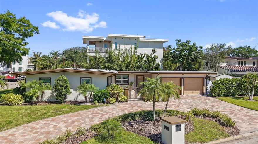 Premier South Tampa Opportunity! Set within the sought-after Beach Park area, this property presents a rare opportunity in a location surrounded by high-end new construction and established luxury homes. Positioned on an oversized corner lot within the Bayshore Estates enclave, the setting offers a unique neighborhood feel with glimpses of Old Tampa Bay and access to one of South Tampa’s most in-demand school districts.

A circular driveway and gated courtyard entry set the tone as you arrive, enhancing the home’s presence and creating a strong first impression while introducing the character of the existing residence. The current home has been thoughtfully updated, blending mid-century modern character with contemporary finishes throughout. Offering four bedrooms, three full bathrooms, and 1,958 square feet of living space, the layout provides a functional flow with well-defined yet connected living areas, designed for both everyday comfort and entertaining.

The kitchen stands out with distinctive cabinetry, quartz countertops, and a modern backsplash, all complemented by updated flooring and statement lighting. Living spaces are elevated by architectural details, including vaulted and coffered ceilings, along with a sleek fireplace feature, while the split-bedroom layout offers added privacy and flexibility.
Outdoor spaces have been equally considered, expansive pool area designed for both relaxation and entertaining. Surrounded by the expansive oversized lot, the setting offers a private, resort-like feel that seamlessly blends indoor and outdoor living, creating an ideal backdrop for both quiet moments and gatherings.
Beyond its current appeal, the property also presents an exceptional opportunity for new construction. Surrounded by multi-million dollar homes and ongoing redevelopment, the oversized corner lot offers the scale and positioning ideal for a custom estate. Whether envisioning a modern coastal design or a timeless architectural statement, this setting provides the foundation to create a residence that fully maximizes both space and presence in a rapidly evolving, high-end neighborhood.

Conveniently located near premier shopping, dining, Tampa International Airport, and the best of South Tampa, this is an opportunity to secure a foothold in one of the area’s most desirable neighborhoods. Schedule your private showing today!