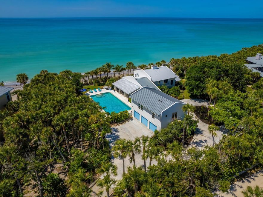 New Price!  This Gulf-to-Bay property offers the best of waterfront living, situated in the private, gated community of North Manasota Key. Located on nearly 1.75 acres and 200 feet of private beachfront, this spectacular beach home is designed for organic, relaxed living in a resort-like setting. The main residence boasts over 3,300 square feet of living space with three ensuite bedrooms, all with balconies overlooking the Gulf of Mexico. The kitchen and family room are the perfect spots to relax and unwind before heading outdoors to capture the magnificent sunset on the beach or simply lounge on the outdoor terrace by the pool. With guests in mind, a newly constructed apartment (2023) over the three-car garage offers two ensuite bedrooms, ample closet space, and a central gathering space overlooking the pool and Gulf of Mexico. All of your family and friends can enjoy this lush oasis and the privacy this property offers. The oversized pool is the jewel of the property for all of your outdoor water fun. An updated dock and almost 200 feet of frontage on Lemon Bay welcome you for your boating pleasure. Take the jet ski to lunch for a special afternoon! Everything about this property says "welcome". Located near excellent schools, golf courses, tennis, shopping, and restaurants, this property is the perfect retreat for those seeking a laid-back lifestyle with just a short distance to Venice or Boca Grande. Don’t miss out on this unique opportunity to experience the ultimate in beachfront living.