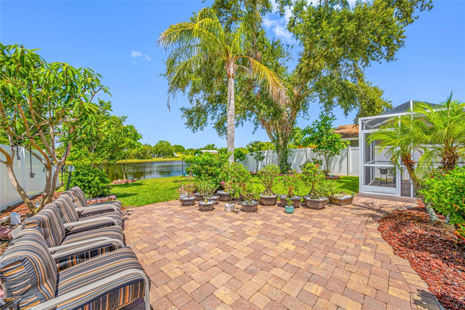 Do you enjoy tropical fruits, this is for you or take it as a Bonus. This won't last at this price. This beautifully maintained waterfront home offers the perfect blend of comfort and style, enhanced by the true Florida lifestyle bonus of lush tropical fruit trees. This well crafted home feature an inviting open-concept floor plan with vaulted ceilings, this residence offers a bright and airy living space that flows seamlessly from the kitchen to the dining and living areas just perfect for both everyday living and entertaining. The kitchen boasts modern cabinetry, stainless steel appliances, and a spacious breakfast bar with seating, complemented by a cozy dining nook overlooking the water. The split-bedroom layout provides privacy, while the primary suite offers a peaceful retreat with its own en-suite bath. Step outside to your private backyard oasis and enjoy serene waterfront views—ideal for morning coffee, evening relaxation, or entertaining friends and family. The property also features a tropical fruit trees, adding to the charm of true Florida living. A waterfront Florida home with a tropical touch, move-in ready and waiting for you!