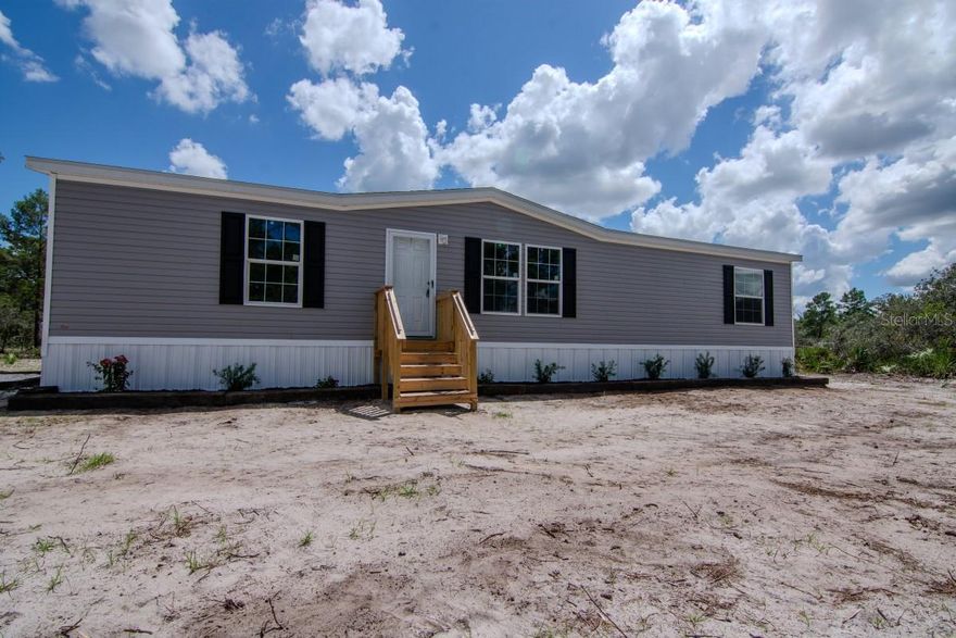 Brand New Manufactured Home on 2.07 Acres
Welcome to your perfect blend of modern comfort and wide-open space. This newly manufactured home sits on 2.07 private acres, offering room to grow, play, or simply enjoy the tranquility of country living—all while staying close to modern conveniences.
Inside, you’ll find 1,494 square feet of thoughtfully designed living space, featuring three spacious bedrooms and two full bathrooms. The open-concept layout includes a stylish kitchen with a center island, upgraded stainless steel appliances, and a brand-new washer and dryer, making this home completely move-in ready.
Step outside to your new 8'x10' deck, the perfect spot to relax and take in the peaceful surroundings. The property is partially wooded with thick, mature trees that can be cleared to suit your needs—ideal for adding a shop, garden, animal enclosures, or other structures.
Everything in this home is brand new, including the well, septic system with drain field, and electrical system. A freshly installed 300-foot gravel driveway leads to a large parking area, offering plenty of space for vehicles, RVs, trailers, or future expansion. Best of all, the property is not in a flood zone, giving you added peace of mind and flexibility for future improvements.
Whether you're starting fresh, downsizing, or just dreaming of more space, this turnkey home is ready to welcome you. Don’t miss the chance to enjoy freedom and serenity.