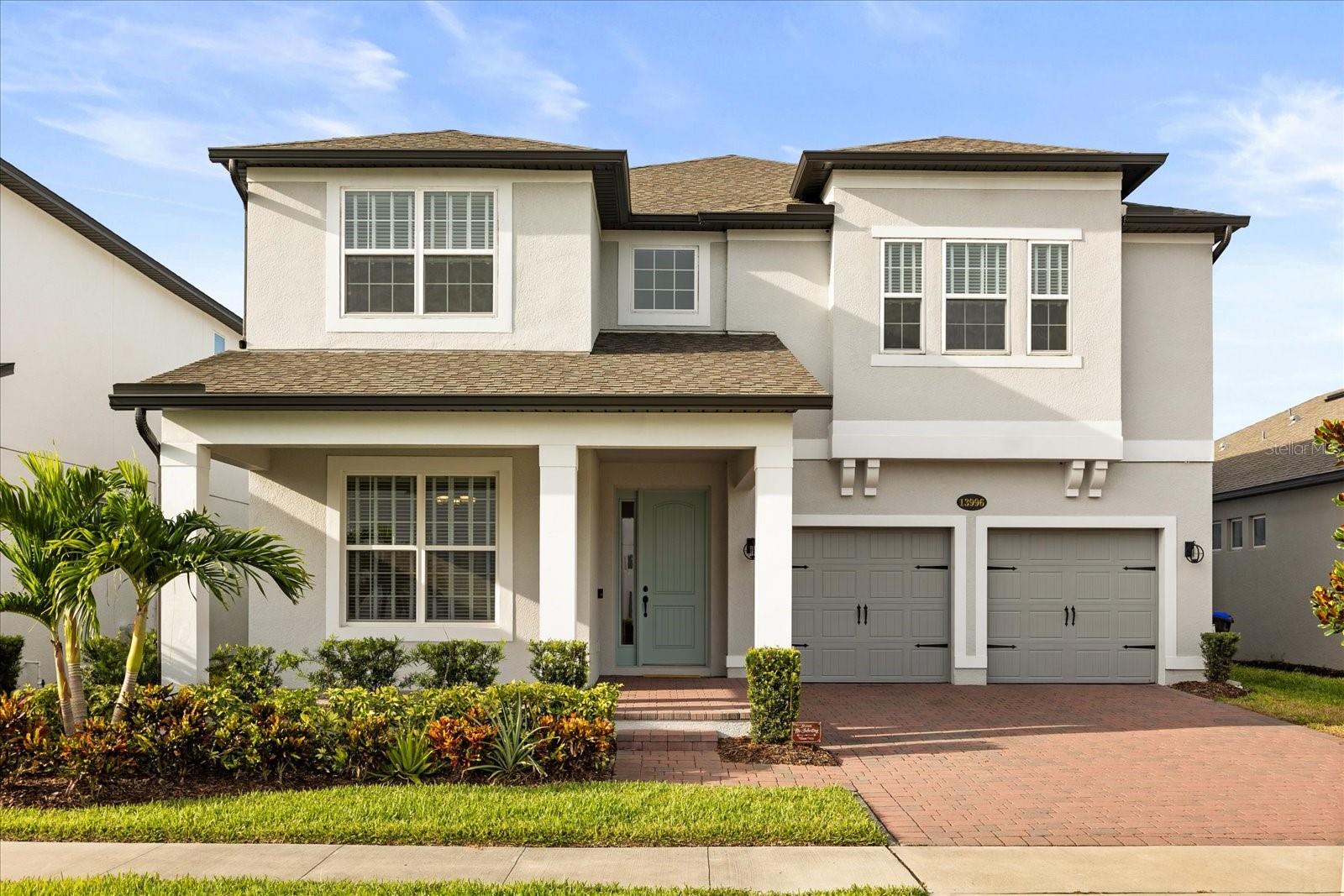 Welcome to your dream home in the vibrant, resort-style community of Encore at Ovation, where luxury, comfort, and thoughtful design come together just moments from the magic of Disney! This spacious five-bedroom, four-bathroom home boasts 3,687 sq ft of beautifully upgraded living space with a serene conservation view, designed for effortless living and entertaining. With expansive interiors, refined finishes, and inviting indoor-outdoor spaces, it’s the perfect setting for creating unforgettable memories. Step inside to discover pristine upgraded tile flooring throughout the main level, while engineered hardwood adds warmth and elegance to the stairs, upper hallway, loft, and expansive primary suite. The gourmet kitchen is a chef’s delight, featuring upgraded cabinetry, countertops, an exterior-vented hood, and a thoughtfully redesigned center island — shifted farther from the cooktop to enhance prep and cooking space, a subtle yet impactful upgrade for culinary enthusiasts. A convenient walk-in pantry adds valuable storage space. Enjoy a designated dining room, ideal for both formal gatherings and casual family meals. A bedroom and full bathroom on the main level, complete with direct access to the outdoor space, offer added flexibility — perfect for hosting guests, multigenerational living, or a private home office. An open-rail staircase leads to a bright, airy loft that enhances the home’s spacious feel. Retreat to the luxurious upstairs primary suite, complete with a spa-like en-suite bathroom featuring dual sinks, a semi-frameless shower, a large walk-in closet, and a private balcony for enjoying Florida’s beautiful weather. The upper level also features three additional well-appointed bedrooms and a generous loft, offering endless possibilities for work, play, or relaxation. Additional highlights include a thoughtfully designed laundry room with built-in cabinetry, ample counter space, and a utility sink for added convenience. A spacious 3-car garage provides even more functionality and flexibility, whether you need extra storage or space for hobbies. The expansive backyard offers the opportunity to create your own private outdoor oasis, with plenty of room to add a custom pool and entertainment area. Situated in the sought-after Encore at Ovation community, residents enjoy access to premium amenities including a clubhouse, fitness center, sparkling community pool, and lawn maintenance services. With premier shopping, dining, and entertainment just minutes away, lifestyle and convenience come together effortlessly. Don’t miss this opportunity to own a move-in-ready home with all the space you’ve been dreaming of!