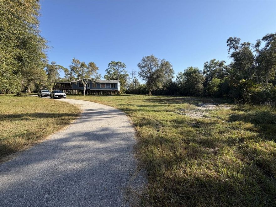 VALUE IS IN THE LAND. HOME IS DOWN TO THE STUDS. Rare 2-acre cleared & filled lot in a prime Fort Myers location! Build your dream estate or family compound just minutes from the highway, RSW Airport, Gulf Coast Town Center, shopping and dining. This property offers peace and privacy while keeping you close to everything. An existing 1,448 sq. ft. stilt structure (on a concrete foundation) with 546 sq. ft open lanai, is ready to be transformed into your dream home. With no HOA, no deed restrictions, and possibly no impact fees (buyer to confirm), you have complete freedom to design your forever home. Acreage like this is nearly impossible to find in such a convenient location—don’t miss this rare opportunity to create your Southwest Florida sanctuary