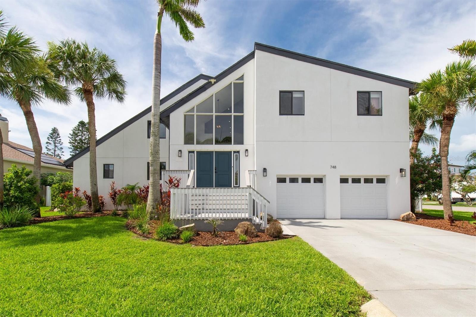 Welcome to 748 Nina Drive—an exceptional 5-bedroom, 3.5-bath pool home nestled in the heart of Tierra Verde, one of the most coveted coastal communities in Pinellas County. Perfectly positioned on a spacious corner lot and a quiet cul-de-sac, this 3,573 sq ft residence effortlessly blends luxury, comfort, and timeless design. From the moment you enter, you're greeted by soaring vaulted ceilings, rich wood flooring, and a sun-drenched living space anchored by a wood-burning fireplace. The designer kitchen is a chef’s dream, complete with stone countertops, stainless steel appliances, and a generous island that flows seamlessly into the open-concept living and dining areas. The main-level primary suite offers a tranquil retreat with a walk-in closet and spa-like en-suite bath. Upstairs, four spacious bedrooms with built-in closets and two full baths provide plenty of space for family or visitors. Step outside to your private backyard oasis, where a sparkling pool, heated spa, and lush tropical landscaping create the ultimate setting for relaxing or entertaining. French doors, cathedral ceilings, and elegant finishes elevate the home's character, while practical features like a spacious laundry room, 2-car garage, and low HOA fees add convenience. *Notably, this home did not experience any flooding during the recent storms, providing peace of mind for future owners. Just minutes from world-class beaches, I-275, and the vibrant culture and dining of Downtown St. Pete, this is Florida living at its finest—where every day feels like a vacation. *Listing agent is related to the sellers. This home is also being offered as a rental option in a separate listing.