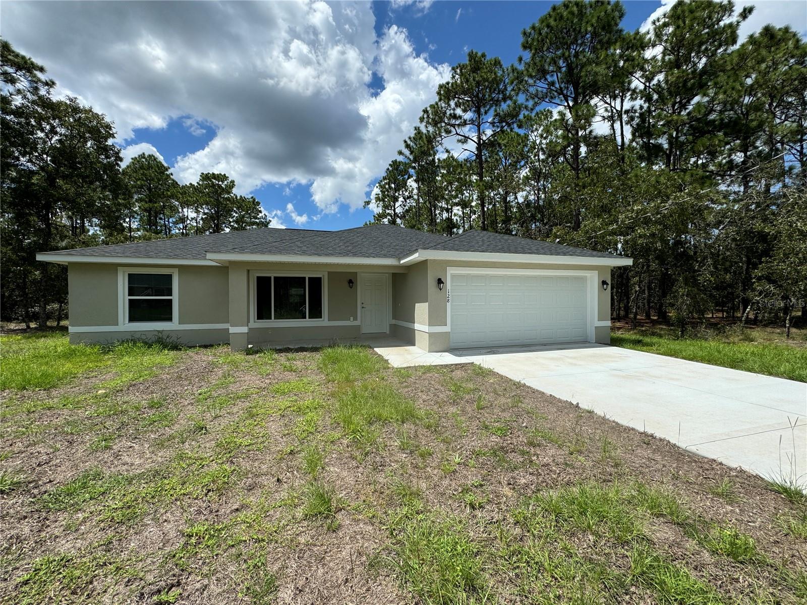 When you walk into this Beautiful brand new 3 bedroom 2 full baths 2 car garage home situated in West Ocala! it smells fresh and like a brand new home! It's conveniently close to the villages, yet offers the best of country living. You'll be the very first to enjoy this stunning home, with its neutral colors make it easy to make it your own. The flooring boasts a beautiful combination of light and dark gray luxury planking, perfectly complemented by white Shaker cabinets, granite countertops and stainless steel appliances. Glass top stove, Dishwasher, Over the stove Microwave, and side by side water and Ice in the door refrigerator. The house is set back from the road, providing a spacious front yard and a nice front porch where you can unwind after coming home from a long day at work. As for the backyard, it's absolutely perfect with plenty of space to entertain guests while playing badminton, croquet, or chipping golf balls. You could even set up a swing for the little ones, or bring the fire pit it would be perfect for those delightful evenings of entertaining guests or just sit out back a view the stars at night! The home has septic and well so no water bill saves you hundreds of dollars every year! The home is very energy efficient! Rest assured, this home will not disappoint. Be the first to see it and make it yours!