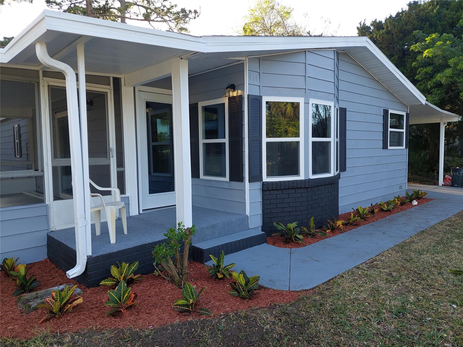 COMPLETELY REMODELED (JUST COMPLETED) - LOOKS LIKE A MODEL. 2 bedroom 2 bath with large screen porch, bay window in the kitchen nook, new roof 11/2021, new double hung windows 2021, new warranted plank floors throughout, kitchen has new appliances which includes French door style refrigerator, stove/oven, dishwasher, microwave, BRAND NEW wood kitchen cabinets w/zero slam doors and drawers, beautiful granite tops, with a center place for stools, new interior and exterior doors, updated and remodeled bathrooms. A/C 2018. All new CPVC plumbing throughout. No more popcorn ceilings or stripe walls, Many more custom features a MUST SEE TO APPRECIATE. One of the larger backyards. Dead end street. Walk or bike to the pool. Be at the beach in 15 minutes. Shopping 5 minutes. Edgewater Landing is a Riverfront active gated community offering intracoastal river access, boat or RV storage (one when available), tennis courts, Bache Ball court, shuffleboard, Riverfront hiking trail, covered gazebo with river view, heated pool, screened hot tub, fitness room -- are just just a few of the many amenities You own your land HOA fees quarterly $545 incudes platinum cable channels and high speed internet, ;Water: City