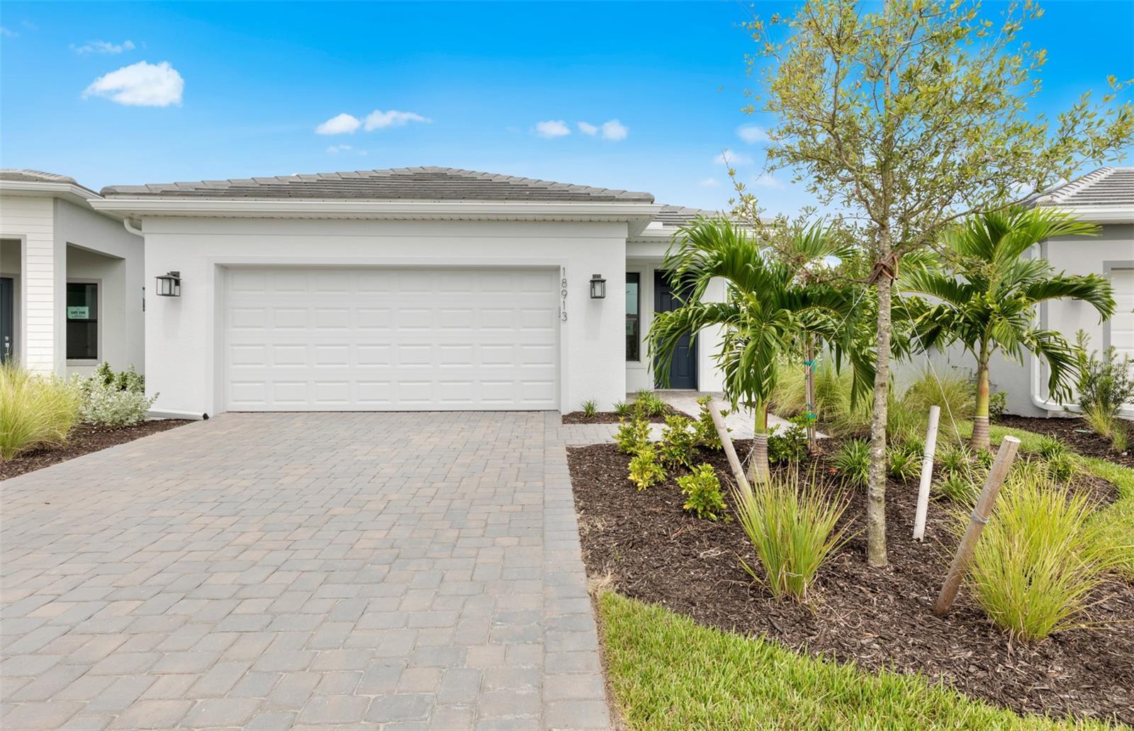 Move into the brand-new Hallmark floor plan, a beautifully designed 2 bedroom, 2 bathroom home with a versatile den, located in Del Webb Catalina—Lakewood Ranch’s newest 55+ resort-style community. This new construction home will be completed in July and offers a host of high-end upgrades for modern comfort and style. Enjoy seamless indoor-outdoor living with a pocket sliding glass door in the gathering room, tile flooring throughout, elegant 5" baseboards, and 8' interior doors for a spacious feel. The kitchen shines with white quartz countertops, a marble mosaic backsplash, pendant pre-wire over the island, and laundry room cabinetry and countertop for added convenience. Additional upgrades include impact windows, epoxy finish in the garage, and more. Live the active lifestyle with access to 12 pickleball courts (8 covered), tennis, bocce, a bar and restaurant, resistance pool, spa, wellness center, golf simulator, and so much more.