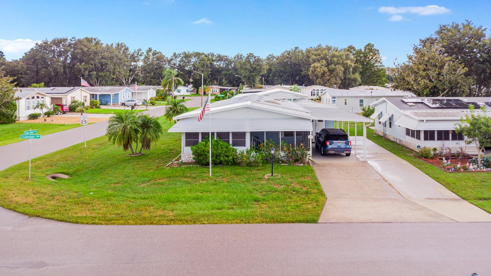 Welcome to 403 Challenger Avenue, located in the highly sought-after active adult golf community of Polo Park. This move-in ready home sits on a desirable corner lot, offering extra space, added privacy, and a comfortable layout ideal for everyday living and entertaining. The spacious kitchen features stainless steel appliances and a bright eat-in area overlooking the front yard. Adjacent to the kitchen is a well-sized dining room, perfect for hosting family dinners and gatherings. The large living room opens to an enclosed Florida room that provides a peaceful spot to relax while enjoying views of the outdoors. The expansive primary bedroom includes a large closet and an updated ensuite bathroom with a step-in tub. Skylights in both the kitchen and bathroom fill the home with an abundance of natural light. Updated laminate flooring throughout adds both style and low-maintenance convenience. In addition to the Florida room, the home offers a screened-in front porch-perfect for enjoying Florida’s breezy mornings and evenings. A spacious storage and workshop area is located at the rear of the carport, A new roof was installed in 2024. The home is ideally located just minutes from Disney parks, shopping, restaurants, medical facilities, and major highways including I-4 and 429. Polo Park offers exceptional amenities such as two clubhouses, two swimming pools, tennis courts, a golf course, horseshoe pits, a fitness center, and a full calendar of social activities—all with affordable HOA fees. This home is a fantastic opportunity to enjoy the Florida lifestyle in a vibrant and welcoming 55+ community.