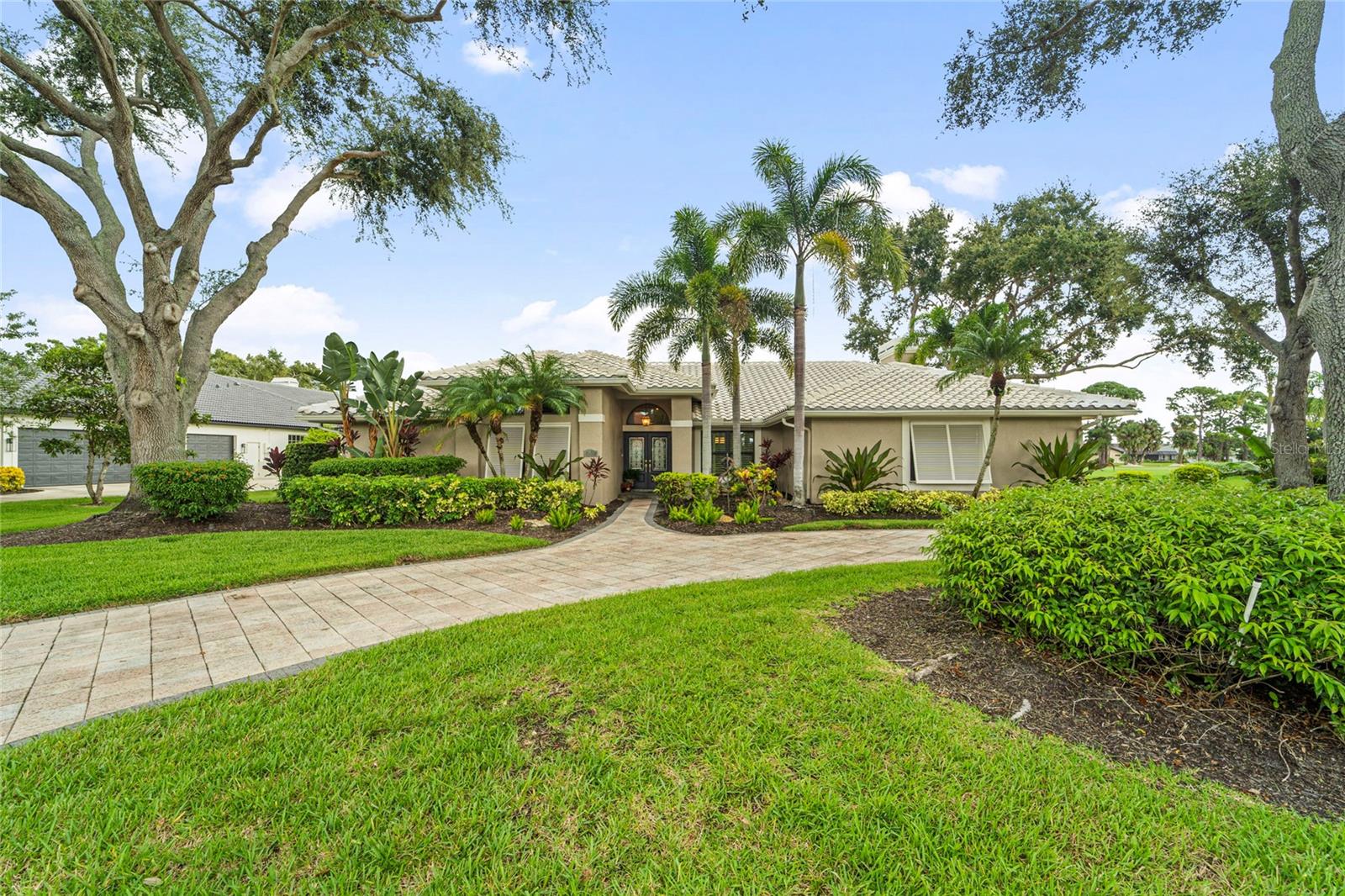 Breathtaking double lake views directly on the TPC PLAYER’S course with Sunsets galore!! Experience refined Florida living in this impeccably maintained single-story residence, nestled within the prestigious gated golf club community of TPC Prestancia. Located on one of the most coveted streets in the neighborhood, this home offers unique views of two glistening lakes and the rolling hills of the golf course, all while ensuring exceptional privacy and tranquility. This property is a bird watcher’s haven! This exquisite residence features 3 spacious bedrooms, 2 bathrooms, a powder room and an office that can serve as a fourth bedroom. The open floor plan, adorned with traditional architectural elements, exudes timeless elegance. The owner's suite is thoughtfully positioned to provide a serene retreat, with two generously sized walk-in closets and direct access to the soaring lanai, stunning pool and hot tub! The guest wing is distinctly separate, ensuring privacy for all. The second bathroom, tastefully updated, serves the 2 generously sized guest bedrooms and the pool area. The kitchen, open to the family room and breakfast area, offers a warm and functional space for everyday living. It includes stainless steel appliances, granite countertops, cherrywood cabinets and a generously sized pantry. The formal dining room and living room provide ample space for sophisticated entertainment, with sliding doors that seamlessly blend indoor and outdoor living, allowing for an effortless flow between the two. Relax in the cozy family room in front of the wood burning fireplace on those rare chilly nights. Step outside to the expansive screened lanai, where a sparkling pool and spa overlook serene lake views—creating a private oasis perfect for both entertaining and unwinding with a spacious covered area for dining "al Fresco". Enjoy peace of mind with IMPACT WINDOWS THROUGHOUT, an annually maintained roof that is only 14 years old, dual-zone A/C systems (2015 & 2021), and an air-conditioned room in the two- cars garage that could serve as a wine cellar or extra storage. The lush landscaping spans over half an acre, enhancing the property's allure. The expansive circular driveway welcomes your guests and adds a touch of style to the front yard. Prestancia Golf and Social Club provides 24/7 gated security and is recognized as an Audubon Certified Sanctuary, with 565 acres of mature trees, wildlife, and walking paths. Tennis, pickleball courts are only minutes away! Located only 5 MILES from world-renowned SIESTA KEY BEACH!! This home blends golf course tranquility with exceptional coastal convenience. TPC Prestancia social, sports and golf memberships are AVAILABLE and optional. Schedule your showing today as this highly sought after floorplan won’t last long!! Floorplan and 3D tour available.
