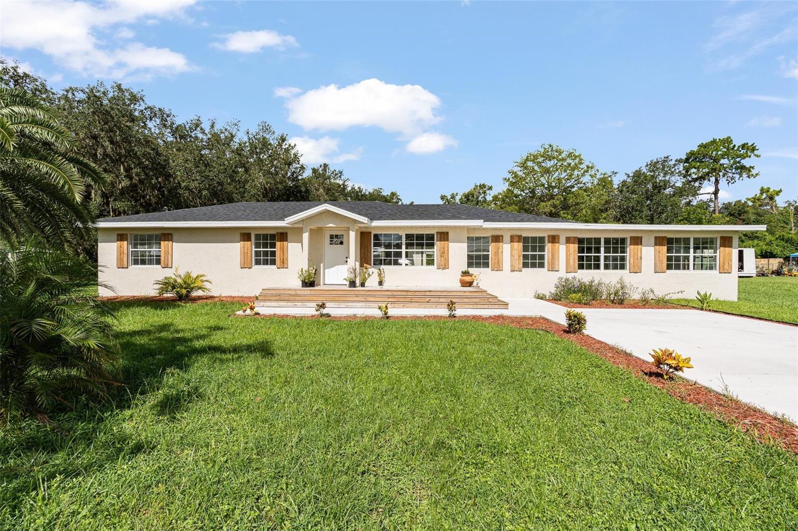 One or more photo(s) has been virtually staged. Welcome to 1518 Lakeside Dr, Deland Florida! This stunning 5-bedroom, 3-bathroom home has been completely remodeled and is ready for its new owner! Situated in a desirable DeLand neighborhood, this property offers a perfect combination of modern updates, versatile living spaces, and everyday convenience. From the moment you arrive, you’ll notice the two separate driveways, offering ample parking for multiple vehicles, guests, or even space for a boat or RV. There also is the option of using second driveway and backside house as a MIL setup with its own private drive and entry way. Step inside and you’ll be greeted by a bright and open layout with fresh paint, new flooring, and thoughtful design touches throughout. The spacious kitchen has been tastefully upgraded with sleek counter tops, beautiful cabinetry, and modern appliances—making it a chef’s dream and the true heart of the home. The open floor plan seamlessly connects the kitchen, dining, and living areas, creating an inviting space for gatherings and entertaining. All five bedrooms feature generous closet space and flexibility—perfect for a large family, guest rooms, home office, or hobby space. Bathrooms have been beautifully remodeled with contemporary fixtures and finishes, giving the home a fresh, polished feel. Outside, the property offers plenty of yard space for all your desires. With no HOA restrictions, you’ll have the freedom to truly make this property your own. Located just minutes from downtown DeLand, Stetson University, shopping, dining, parks, and major roadways, this home provides easy access to everything you need while still offering a peaceful residential setting.