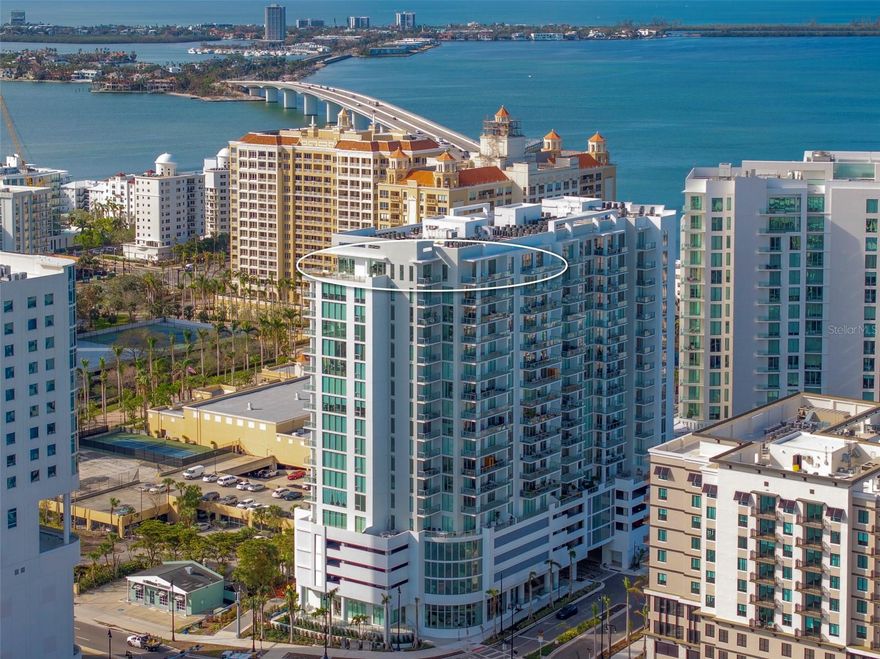 High above Sarasota's vibrant Downtown, this extraordinary 19th floor Bayso penthouse features unparalleled luxury with breathtaking Bay vistas in every direction and an impressive 1500+ sf terrace. Completed in December 2023, the custom-designed 3600 sf open floorplan with 3 bedrooms plus den/media room, 3.5 baths boasts dramatic floor-to-ceiling glass walls on three sides, bathing the interior in natural light and framing every room with spectacular water and skyline views. The remarkable outdoor living space includes 3 thoughtfully designed terraces with a custom glass railing system that ensures unobstructed sweeping bay views.  The wrap-around terrace flows seamlessly into the stylish great room and creates a wonderful indoor-outdoor lifestyle perfect for daily life, intimate gatherings and grand entertaining. The contemporary chef’s kitchen is a true work of art, showcasing exquisite fixtures, materials and finishes; sleek Italcraft full-height European cabinetry, all stainless Jenn-Air Professional appliances including a convenient under counter wine cooler and generous Quartz topped counters and island. The additional prep kitchen with second dishwasher and ample European cabinetry ensures effortless entertaining. The primary suite is a peaceful sanctuary with its private terrace, where glass railings seem to disappear into the horizon, creating an infinite view of water and sky. The space is inviting and features two large walk-in closets. The ensuite bath rivels that of a luxury spa with a serene soaking tub, multi-jetted glass and porcelain surround walk-in shower, floating Quartz topped vanity with a contemporary eased edge, dual sinks, designer porcelain flooring and fantastic natural light. Two generously appointed guest suites share another large terrace with fantastic views. Each room boasts richly appointed ensuite baths, providing luxurious accommodations for family and friends. A separate and private bonus room area offers flexibility for a home office, media room, den or library. The well-appointed powder room and large in-unit laundry room featuring ample cabinetry and large capacity, front load Whirlpool washer and dryer complete the space. Custom finishes include hurricane-rated windows, 8' solid core doors, imported, large-format porcelain tile floors, smooth finish ceilings and walls, and generous recessed lighting throughout. 2 premium parking spaces and additional climate-controlled storage are included with the penthouse. Further enhancing your luxury lifestyle, Bayso’s world-class amenities rival those of five-star resorts. Unwind at the elevated resort-style pool with ample lounging areas, a pergola-covered grilling station, and outdoor dining spaces for memorable gatherings. Residents enjoy a modern club lounge with catering kitchen, fully equipped fitness center, private conference room, and dog park with a water fountain, 24-hour concierge service and onsite property management for a seamless living experience. Perfectly situated in the heart of Sarasota’s vibrant downtown, you are mere moments away from The Bay Sarasota, world-class dining, beaches, arts, and cultural venues. Experience sophisticated urban living at its finest in this meticulously curated, one-of-a-kind residence offering stunning views and unparalleled luxury.