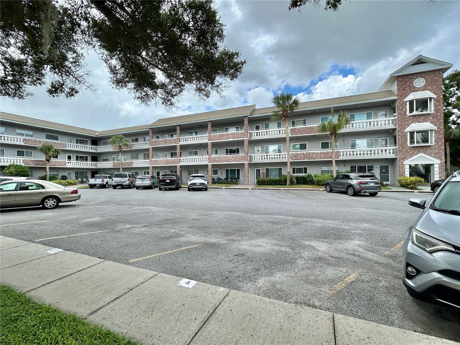 **The Seller is offering a $5,000 credit at closing towards the installation of a washer and dryer!** Welcome to your meticulously furnished second floor, 2 bed, 2 bath oasis, ideally situated on a quiet cul-de-sac that backs up to a lush, green conservation area. The updated kitchen features chic shaker style cabinets and unique butcher block counters with a French Farmhouse-style sink, a ceramic tile backsplash, newer appliances, and ceramic tile flooring. Extra cabinets and counter space make this kitchen a true delight for any home chef. Both bathrooms have been tastefully updated, featuring comfort-height commodes, modern lighting and mirrors, vanities and faucets, offering a blend of style and functionality. Relax in the convenience of the Florida Room and gaze out through the updated windows at the serene view of the mature trees and greenery of the conservation area. As an added bonus, there is a bump out on the front balcony providing enough room for a small table and chairs to sit outside and wake up with your morning cup of coffee, or relax with a glass of your favorite beverage while you watch the sunset in the evening. The AC was replaced in 2021 and there are ceiling fans in the bedrooms and Florida Room to help keep you cool. The water heater was replaced in 2015. Located in a vibrant 55+ community, you'll have access to a wide range of amenities designed to enhance your lifestyle. Enjoy two private golf courses (9 and 18 holes), two heated swimming pools, and two activity centers. Stay active in the remodeled cardio gym or engage in various community activities like fitness classes, dancing, clubs, cards, and billiards. Pet owners will love the pet-friendly environment, featuring a fenced dog park and covered seating areas. Residents can also enjoy hobby studios and a woodshop for creative pursuits. The on-site Good Karma Café offers convenient 'take & bake' meals and snacks. Conveniently located near beaches, transportation, shopping, entertainment, and fine dining. Schedule your showing today and enjoy the best in comfort and convenient living!