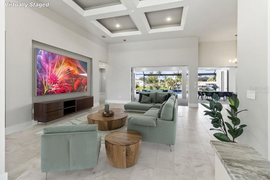 Stunning New Construction home on a wide direct sailboat gulf access lot! This exceptional never-lived -in home is perfectly positioned in one of Cape Coral's most sought-after neighborhoods. With 2611 sq. ft. of elegant living space, this residence offers the perfect blend of modern luxury and relaxed coastal living. It's designed to maximize water views and create the ultimate indoor-outdoor living experience. From the moment you walk through the front door, your eyes are immediately drawn to the sparkling infinity pool and spa, the outdoor kitchen, and the expansive lanai area overlooking the shimmering wide water canal. The pocket sliders disappear to create a seamless flow between the open-concept interior and your private waterfront oasis-perfect for entertaining or simply enjoying the Florida sunshine and breathtaking sunsets. The saltwater pool and spa are with a state-of-the-art-heating and cooling system ensuring year-round comfort, while the outdoor shower and outdoor kitchen make alfresco living effortless. The home features 4 bedrooms plus a den and 3 baths with three bedrooms offering en-suite baths and one also serving as a convenient pool bath. 3 car garage, the kitchen features beautiful quartz waterfall countertops, stainless steel appliances, and custom cabinetry. Tile throughout the entire home and everything in neutral colors so the new owners can bring in any colors they prefer with their own decor. The picture-screened enclosure frames panoramic water views while maintaining an airy, open feel. With direct sailboat access and no bridges or locks, this is a boater's dream come true. Brand-new construction and never occupied, this home delivers the perfect blend of luxury location, and lifestyle. Where every day feels like a vacation-welcome home to waterfront living at its finest.LISTING AGENT TO ACCOMPANY ALL SHOWINGS.