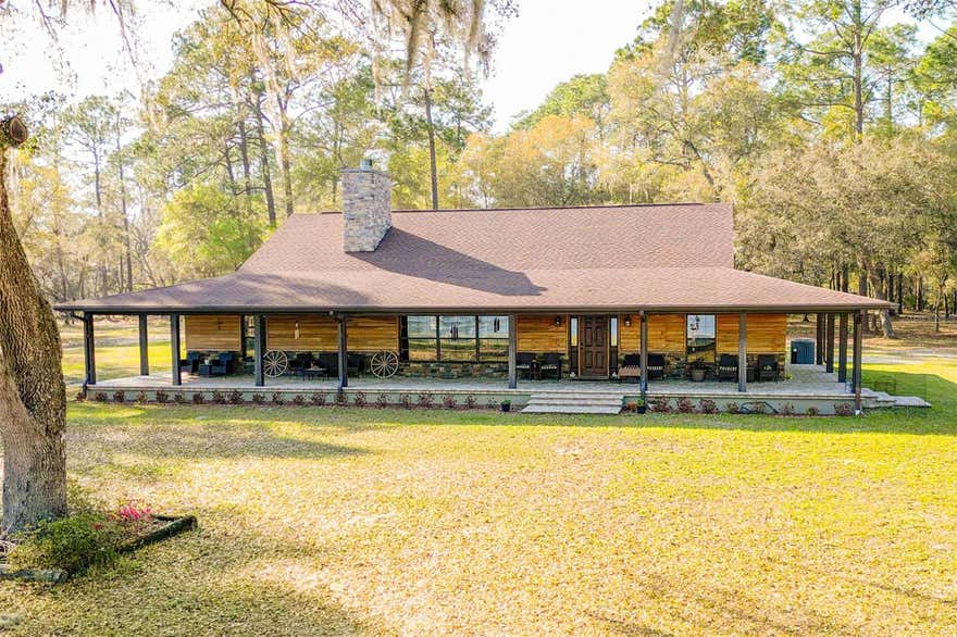 Silver Springs Estate on Lake Fore is a truly rare 9.78± acre inholding within the Ocala National Forest, offering unmatched privacy, lake frontage, direct access to nearly 400,000 acres of protected wilderness, and with a price of only $117,587 per acre. This high-and-dry property is surrounded by the forest and features exclusive access to Lake Fore, a crystal-clear, sand-bottom lake where this is the only privately owned parcel. Ideal for kayaking, fishing, swimming, and quiet recreation-no motorized boats permitted. The 2,508 sq ft residence (built 2008) includes 3 bedrooms, 2 bathrooms, an open great room with a stone fireplace, high ceilings, and a functional, move-in-ready layout that blends seamlessly into the natural surroundings. A 30' times 40' workshop provides ample space for equipment, storage, and projects. Wildlife is abundant, hunting is permitted (per regulations), and the setting delivers a true Old Florida experience-while remaining just minutes from Silver Springs and Ocala conveniences.
