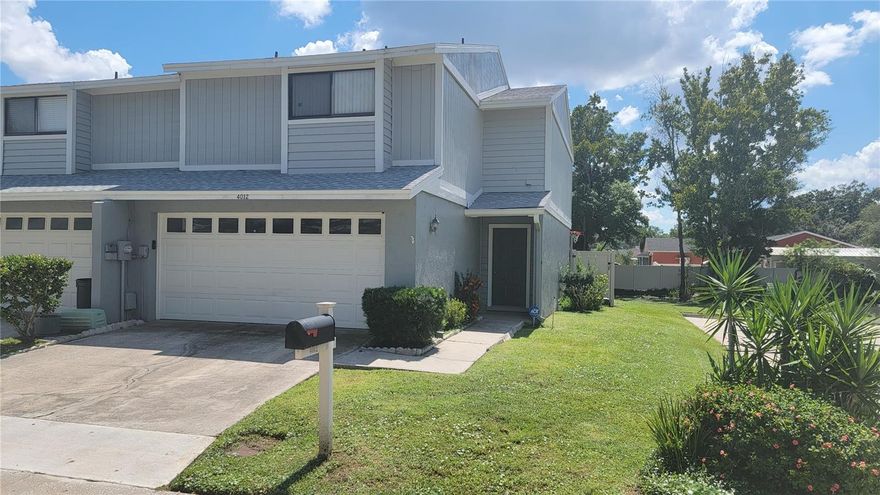 PRIME INVESTMENT OPPORTUNITY OR A GREAT PLACE TO CALL HOME! Great tenants currently in place until October 2026, so built in income from the start! NEWER ROOF (2022) BRAND NEW A/C (2025) Lovely townhome nestled within the peaceful community of Jasmine Pond right in the heart of Tampa. This CORNER END UNIT townhome is spacious with over 1600 square feet and has a nice open floor plan with soaring ceilings. The functional layout features a great room concept on the main floor, where you will find tile flooring throughout and lots of windows letting the outside in. The kitchen has granite countertops, with a practical breakfast bar, NEWER REFRIGERATOR (2024) NEW DISHWASHER (2025) a pantry closet, and direct access to the TWO-CAR GARAGE. The living and dining areas flow together easily, making for a comfortable daily routine. A convenient half-bath is also located downstairs for guests. Upstairs, the home offers two bedrooms, each with its own full bathroom, and carpet provides a soft layer of comfort. The guest bedroom features a lovely balcony overlooking the PRIVATE, FENCED-IN PATIO and small pond. For added convenience, an upstairs utility closet houses the INCLUDED NEW WASHER AND DRYER (2025), simplifying your laundry routine. As a corner unit, you can enjoy quiet moments with NO BACKYARD NEIGHBORS.  This well-loved home is also equipped with a SECURITY SYSTEM which makes for peace of mind in a prime location. The community also offers access to a SPARKLING POOL for residents to enjoy. Call today to make an appointment to see this well priced home in a highly desirable location! Room sizes are estimated.