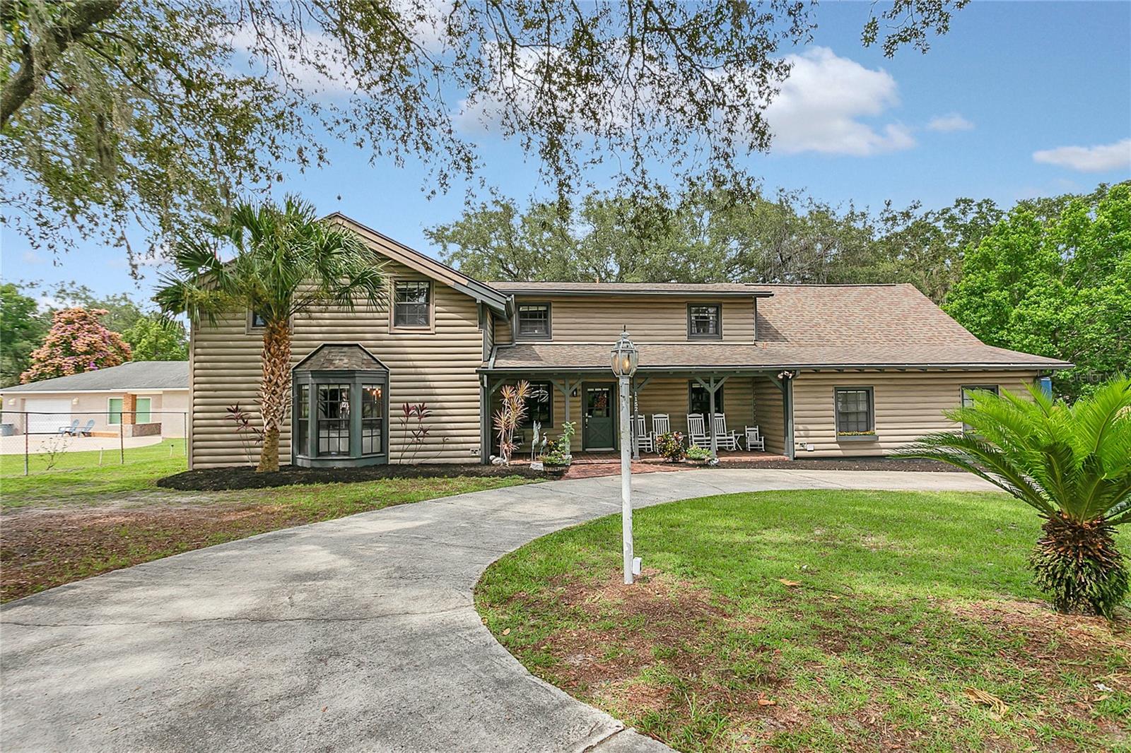 Discover the perfect balance of modern comfort, relaxed living, and small-town charm in this one-of-a-kind 5-bedroom, 3-bath, 3,839 sq ft lakefront home on peaceful Lake Hodge in Casselberry. . . . . . .
Set on over half an acre, this property offers mature trees, no local taxes, and generous parking—including a circular driveway, RV hookup with a 50-amp receptacle, and room for commercial vehicles. With well water and a 5-piece filtration system, plus a private septic, it’s built for both ease and independence. . . . . . .
Step inside and be welcomed by vaulted ceilings, natural light, french doors and beautiful views of the lake. The open-concept great room features 20-foot ceilings, exposed beams, oversized remote-controlled ceiling fans, and a 12-foot brick fireplace, flanked by built-in shelving and bay windows that bring the outdoors in. . . . . . .
At the heart of the home, the professional-grade chef’s kitchen is a showstopper—complete with two built-in refrigerators, a 5-burner gas range with convection oven, pot filler, dishwasher, granite counters, stone backsplash, and a 36-inch stainless farmhouse sink. A 12-foot walnut butcher block island, built-in farmhouse table with seating for 10+, and dual pantries make this kitchen ideal for everything from weeknight meals to weekend gatherings. . . . . . .
Connected to the main living area is an entertainer’s dream: a screened-in outdoor kitchen with granite counters, 8-burner grill, flat-top griddle, two side burners, beverage fridge, and a custom 10-foot hood system. Enjoy outdoor movie nights with the 105-inch projector screen, surround sound, ceiling fans, and recessed lighting—all with easy access to the deck and above-ground pool. . . . . . .
The first-floor primary suite offers a quiet retreat with double vanities, a walk-in tiled shower with bench, and direct access to the outdoor space. Also downstairs: a second bedroom (or office/flex space), laundry room, half bath, and rear garage/workshop. . . . . . . .
Upstairs you'll find three spacious bedrooms, a full bath, a loft overlooking the great room, and a built-in desk area—perfect for schoolwork or remote work. . . . . . .
Other standout features include--Grey wood-look ceramic tile flooring.
Custom barn doors and wood ceilings.
Updated lighting fixtures throughout. . . . . . .
This home is perfect for those who love to entertain, spread out, or simply enjoy peaceful mornings with coffee and lake views. Whether you’re raising a family, hosting holidays, or escaping into your own private retreat, this home offers space, style, and serenity. . . . . . . .
Come experience life on Lake Hodge—where every day feels like a getaway. Roof 2016. Water Heater 2024.