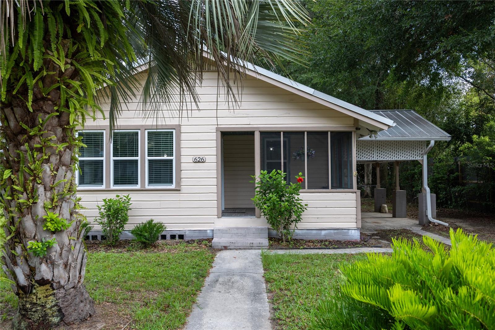 One or more photo(s) has been virtually staged. This adorable home with an abundance of natural light is located on a quarter acre. The living room and dining room have original wood floors. All bedrooms have vinal plank flooring and no carpet anywhere. The fully fenced yard has a 12 X 16 workshop with a loft and electricity. Front porch and back porch add to the charm. This property works well as a short-term rental or a great starter home. It is a short distance to UF and retail on NW 13th Street. Some of the pictures are virtually staged.