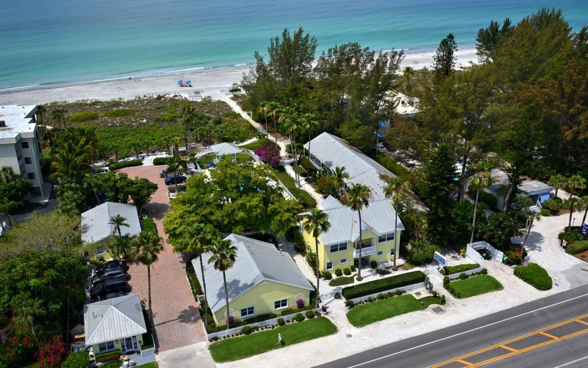 Sought after slice of beachfront paradise on the exclusive island of Longboat Key. Rarely available 2 acre property with 200 feet of beach frontage on the Gulf of America. Currently it hosts a quaint inn featuring ten suites and one cottage, all had been renovated with timeless old Florida decor. The property is surrounded by tropical blooms , lush foliage, vine covered arbors, swaying palm trees, a private gazebo, and a heated swimming pool. Amazing opportunity for a new development, or alternatively a chance to easily bring the property back to its recent glory. The property has been approved to build two single family homes or a six unit luxury Condominium. This fantastic location is near the growing number of top restaurants and attractions . Walk to Harry's Euphemia Haye, Lazy Lobster, new local favorite Lo' Key or stroll over to the bay at Durante Park. All this is just a short drive to the renowned shopping, dining and cultural attractions of St Armands Circle, as wells Downtown Sarasota and Anna Maria Island. So many possibilities for this location, location , location !