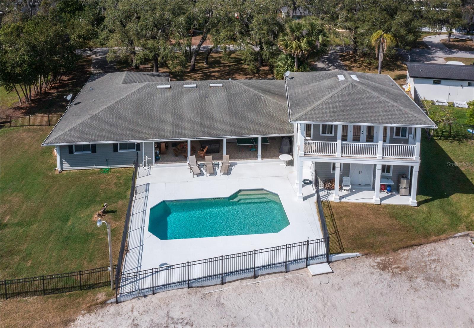 One or more photo(s) has been virtually staged. PROPERTY PRICED BELOW APPRAISED VALUE! Here is your opportunity to enjoy LAKEFRONT PROPERTY on the highly sought after LAKE RENA THAT CONNECTS TO LAKE BRANTLEY! Bring your boat, jet ski, kayak, etc. and enjoy the LAKE LIFESTYLE. Imagine having this 141 FEET of WATERFRONT SHORELINE to enjoy every day. This property is one of the largest lots on LAKE RENA. You won’t have to worry about noisy boats and jet skis zooming by your dock since Lake Rena has a no wake zone. What is even better there are NO HOA fees unless you prefer to pay the “optional fee” of $150/year for your own key to access the private “neighborhood boat ramp” on Lake Rena. This spacious home has 4 bedrooms, 2 full baths and 2 half baths in the main part of the home. You are able to view the lake from the kitchen, family and some of the bedrooms. Besides the 2-car garage on the side of the home there is an addition that also has an OVERSIZED 2-car garage with garage doors in the front and rear which makes it is easy to park trucks, SUVs jet skis etc. Above this garage is an additional living space that could be used as IN-LAW SUITE, GUEST QUARTERS or even a GAME ROOM. This area includes a kitchenette, living/dining area and a bedroom/bathroom. When you step out of this living space there is a huge BALCONY with a magnificent view of the lake. The circular driveway provides plenty of parking for guests. The huge back covered porch that overlooks the pool makes a great space for entertaining. There are even 2 outdoor showers. This property is zoned for Seminole County schools. Conveniently located to shopping, restaurants and SR 434, SR 436 and I-4. Wekiva State Park and Wekiva Island are right down the street! So hurry and schedule your tour because this HOME and LIFESTYLE will not last long! This property did not flood from Hurricane Ian, HIGH AND DRY!