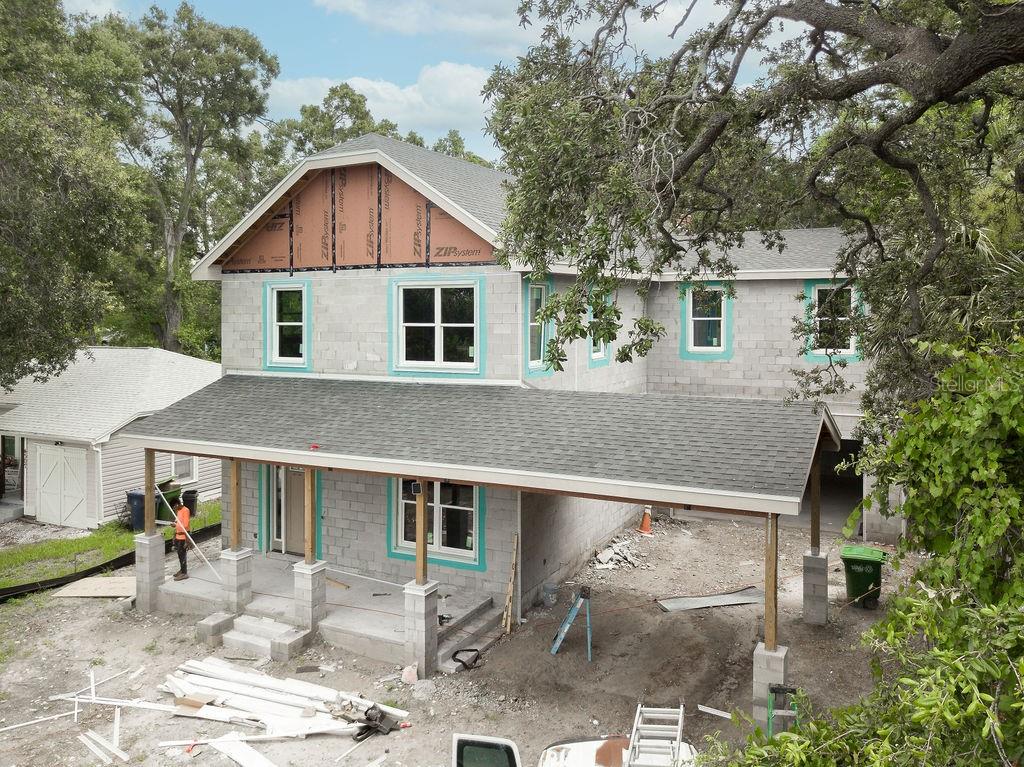 Under Construction. CHECK OUT OUR INTERACTIVE VIRTUAL TOUR! Experience refined living in this exquisite 5-bedroom, 3.5 bathroom new construction home offering a seamless blend of timeless architecture and modern luxury. This 2-Story block home with impact windows is thoughtfully designed to handle Tampa's toughest weather. This residence features a spacious two-car garage and a distinguished porte cochère (carport) that enhances its stately curb appeal.
Step inside to soaring ceilings and an open layout anchored by a dramatic great room with a custom fireplace, creating a warm and inviting focal point for gatherings. The gourmet kitchen opens effortlessly to the living and dining spaces and includes a separate butler’s kitchen, ideal for entertaining and everyday functionality. Adjacent to the kitchen is the dining room including a stylish wet bar, perfect for hosting in style.
The home’s architectural character is evident in every room, with high-end materials, and thoughtfully curated design elements throughout. A generous bonus room offers flexible space for a gymnasium, home office, media room, or playroom, adapting to your lifestyle needs. The expansive primary suite features a luxurious en suite bath, with premium fixtures, and bedside wet bar to help start or end your day. while four additional bedrooms provide plenty of room for family and guests.
Enjoy year-round outdoor living on the screened-in lanai, which offers privacy and comfort for relaxing or entertaining. The backyard is designed with space and infrastructure in place for a future swimming pool (Optional), offering the perfect opportunity to create your own private outdoor oasis.
Located in Southeast Seminole Heights, one of Tampa’s most vibrant and growing neighborhoods with top-rated local eateries, walking distance to Hillsborough High, and Giddens & Robles Parks. This home is a true showpiece that blends comfort, sophistication, and functionality. Don’t miss the opportunity to own a one-of-a-kind new construction home with custom finishes and distinctive design. Schedule your private showing today!