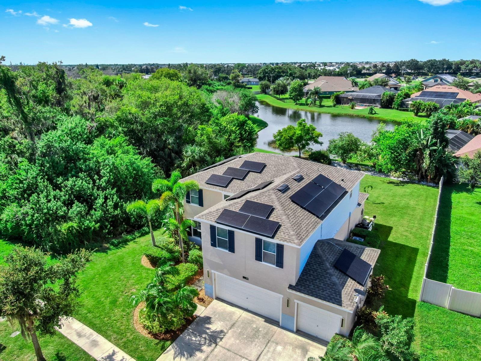 Located in the beautiful community of Harbour Isles, this four-bedroom POOL home is fully equipped with SOLAR panels, offering the immediate comfort of low electric bills. This home features many upgrades, custom finishes, accent walls, and move-in readiness. The lower level showcases hardwood and tile flooring, with luxury vinyl extending up the stairs to a spacious landing. A chef's dream kitchen features thoughtful upgrades and dynamic design, stainless steel appliances, a large island, and a bar area with a wine refrigerator. Sliding doors open to a private backyard oasis complete with a covered patio, bar area, paved deck, and sparkling screened-in pool with no-see-um screening. The lot is one of the most private in the neighborhood, bordered by conservation on the side and a serene pond in the back. Upstairs, the expansive primary suite boasts an upgraded bath and an oversized walk-in closet, while three additional large bedrooms share a beautifully updated bathroom. ROOF 2023. 3-car garage. The community offers a resort-style pool, fitness center, basketball hoop, volleyball court, playground, walking trails, fishing, boat & RV storage. Ideally located just minutes from Tampa, MacDill AFB, Brandon, St Pete, Sarasota, and Bradenton. Quick access to I-75, US Hwy 41, Hwy 301 with easy drives to Florida's top beaches, Orlando attractions, and several airports. This home truly has it all, come see this gem today!
