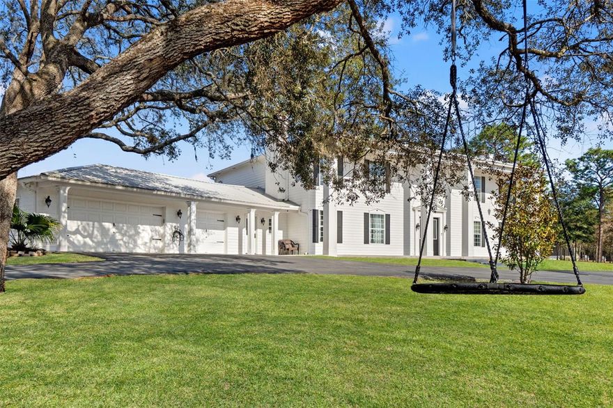 Inspired by classic Colonial architecture and the grandeur of the White House, this extraordinary estate offers refined living on a private 2.40-acre setting with no HOA, no CDD, and AR2 Agricultural Residential zoning—giving you space, freedom, and flexibility. With 4 bedrooms, a private office, 3 full baths, 2 half baths, and 4,240 square feet of living space (6,334 total square feet including the garage), every detail has been thoughtfully designed for both elegance and comfort.From the moment you arrive, the home makes a statement. A gated, fully enclosed property opens to a stately residence where a dramatic two-story foyer welcomes you inside. A breathtaking chandelier cascades light over a custom quartz staircase with modern cable railing, setting the tone for a home that blends timeless design with contemporary sophistication. Formal sitting and dining rooms frame the entry, ideal for entertaining or quiet moments alike.At the heart of the home is a chef’s kitchen that is nothing short of exceptional. Designed for both function and beauty, it features premium Dacor appliances, including double ovens, a 48-inch dual-fuel steam range with griddle and six-burner gas cooktop, double-column refrigeration, built-in freezer drawers, a Dacor dishwasher, and a Miele espresso maker. A generous quartz island anchors the space, complemented by a walk-in pantry, butler’s pantry, built-in ice maker, and a charming eat-in nook overlooking the pool through a sunlit bay window.The living spaces are equally inviting, with luxury vinyl flooring, custom finishes, and three wood-burning fireplaces that add warmth and character throughout. A custom home theater living room elevates entertainment, featuring professionally installed KEF surround sound, in-wall and in-ceiling speakers, a subwoofer, and Denon receiver—all seamlessly controlled by a Savant remote. (Projector and screen available separately.)Upstairs, four spacious bedrooms provide comfort and privacy. Two guest suites offer en-suite bathrooms and custom closets, while the primary suite is a true retreat. This serene space includes a private balcony overlooking the pool, a spa-inspired bath with dual vanities, rainfall shower, and garden tub, plus an expansive custom closet complete with center island and a secure armory room.Security and peace of mind are paramount, with a motorized main gate, service gate, ADT security system, full camera coverage, and a dedicated safe room with surveillance monitors.Modern conveniences abound, including two new 5-ton Trane AC units, a tankless water heater, Generac generator with 350-gallon propane tank, water softener, new well pump and tank (2024), EV or camper 30-amp hookup, oversized laundry room, and a pristine epoxy-floored garage with craftsman workbench.Step outside to your own resort-style oasis. A heated Pentair pool with waterfall is surrounded by refinished pavers, while a gazebo invites evening gatherings and a greenhouse offers year-round gardening. Every element of this estate has been curated to offer luxury, privacy, and a lifestyle that feels both grand and effortlessly livable.