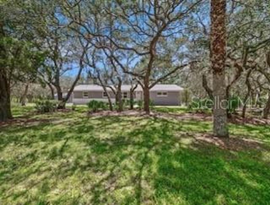 Country living within minutes of the city! All the privacy you could want on OVER AN ACRE/CORNER LOT, in a PRIME LOCATION on the border of Chuluota/Oviedo - COMPLETELY RENOVATED and ZONED FOR A-RATED SEMINOLE COUNTY SCHOOLS. Tucked away between the entrances of the highly sought-after Live Oak Reserve Community and surrounded by million dollar plus lakefront homes on Lake Eva. This 3BD/2BA home sits surrounded by gorgeous Oak trees and is fully fenced with two yards. The property is zoned agricultural so bring your farm animals. Everything has been updated with impeccable detail from the ROOF, KITCHEN & BATHS, FLOORING, modern paint inside and out, WINDOWS, stucco, a WATER HEATER. This beautiful home is MOVE-IN READY! The OPEN CONCEPT feels light and bright from the moment you walk in the front door. Every angle of this home lookouts to nature views. WOOD LAMINATE FLOORS and kitchen finishes have a fresh and upgraded appeal. The kitchen is fully equipped with UPGRADED STAINLESS STEEL APPLIANCES, plenty of storage and a large
ISLAND with a farmhouse sink and bar seating! Off the kitchen is the perfect space for dining and entertainment. The bedrooms are all spacious, including your PRIMARY SUITE delivering another bright space with a built in closet and private bath. The master bathroom also been completely renovated in the same style as the kitchen with a DUAL SINK VANITY, chic light fixtures and a custom tile walk-in shower! The two additional bedrooms share a second full bath, also updated with waterfall shower and bath. The screened Lanai / Back Porch is the perfect place to enjoy the views this property delivers, a ceiling fan ensures comfort while you cookout with family and friends. The large main backyard feels private and endless with ample space for gardening, dining, and entertaining. The secondary yard boasts the water shed, screened in back porch, and nature views. A large well maintained SHED for storage that is currently utilized as a chicken coop with outdoor run matches the homes exterior. in addition to the pristine 2-CAR GARAGE, there is a enclosed room that will suit all your storage needs. The home has a circular driveway and uncovered car port for extra parking. Across from Lake Eva road the property extends into the woods that is perfectly maintained and fenced. The convenient location just off County Road 419 makes it easy to access all that Oviedo has to offer - phenomenal schools, local parks, recreation, shopping, dining, Oviedo on the Park and so much more! This kind of opportunity doesn’t come along often, a feels-like-new home on over an acre in the perfect location!