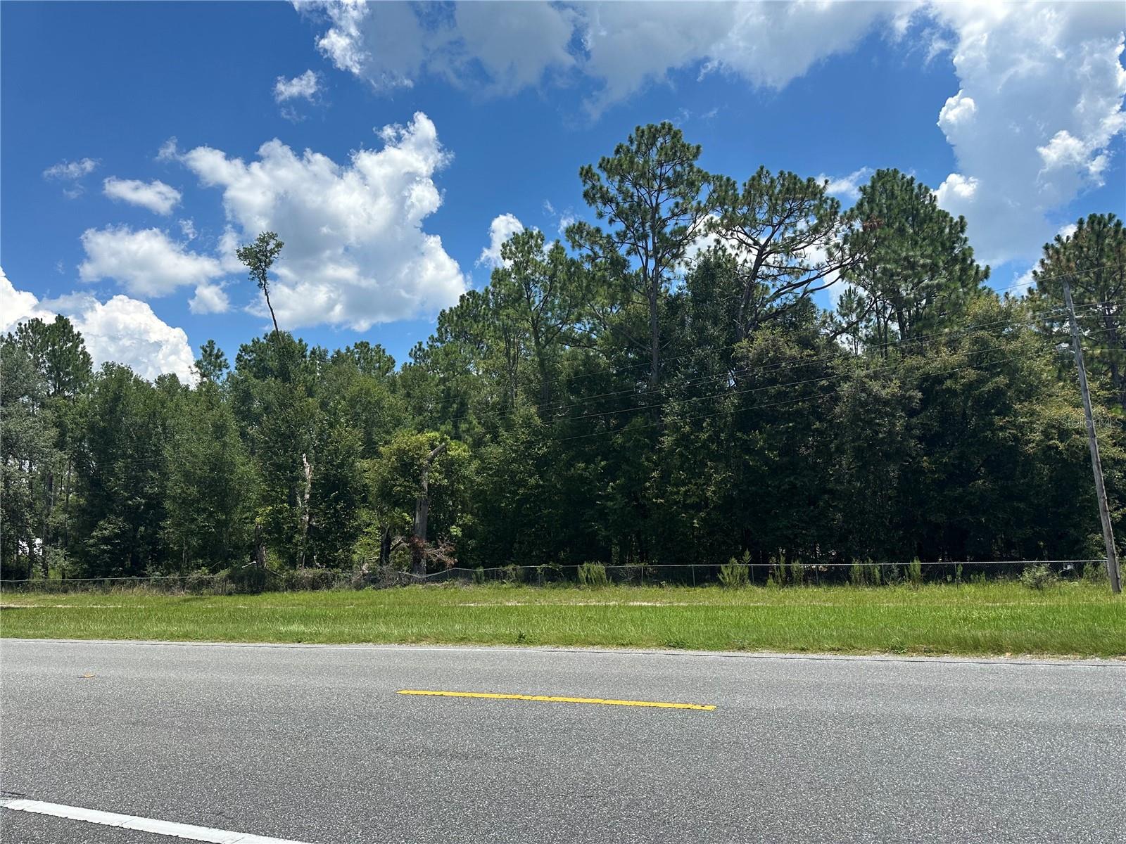 Own 5 wooded acres with planted pines and mature trees, partially fenced on 3 sides in High Springs, Columbia County, off of 441: a well-suited site for your next build or long-term investment. This AG-3 zoned property allows for a variety of permitted uses, including single-family homes, modular, manufactured, and tiny homes, as well as pole barns. The land is wooded, providing natural privacy with a clean slate for future development. Located outside of any flood zone and with no wetlands present, the property ensures straightforward site preparation. Paved road access also makes entry convenient, and electric service is available nearby. Enjoy easy access to popular natural attractions. Ichetucknee Springs State Park, Ginnie Springs, and O'Leano State Park are within a short drive. Whether you're looking to build, hold, or explore, this parcel puts you in a prime North Florida location with room to grow. Don’t miss the chance to make it yours!