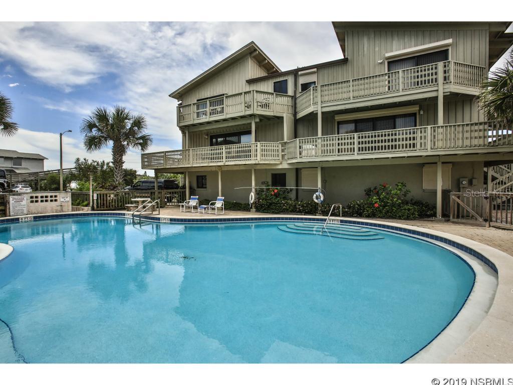 Ocean Views and Ocean Breezes await! This beautiful 3 bedroom, 2.5 bathroom townhouse is part of the Green Turtle Sea Dunes community on NSB's No-Drive Beach! The enormous main living area includes an open floor plan: Kitchen, Living/Dining, a private Den (optional 4th bedroom) and a private half bath. Off the living room is a large open deck overlooking the pool and ocean views. Upstairs are three spacious bedrooms and two full bathrooms. The master suite enjoys a private ocean view balcony. On the ground floor is a private garage - room for all your toys and your car. This property is offered furnished. Green Turtle has its own pool, tennis court and private walk to the beach. Weekly Rentals allowed. Check out the virtual tour and photographs to fully appreciate all this special property offers. ;Water: City