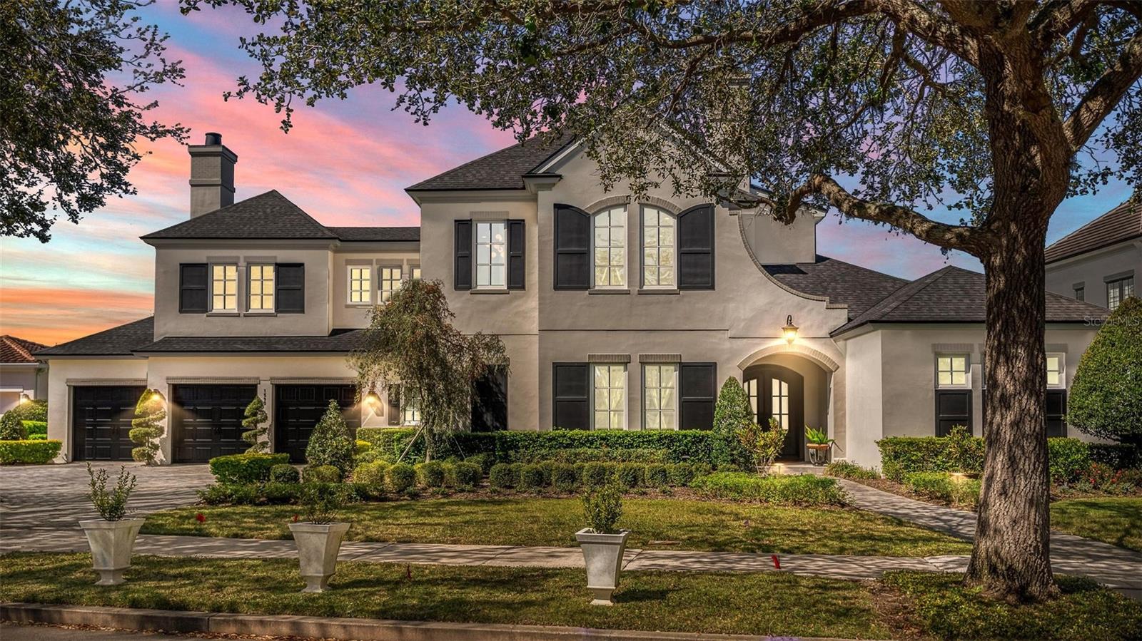 Custom-built by Dave Cahill Homes, this Baldwin Estate Sanctuary offers ultimate backyard privacy and scenic nature walks! Situated on an oversized lot with a spacious 3-car garage and brick-paved driveway, this “French Contemporary” home is open, airy, and filled with natural light.
The residence features 5 spacious bedrooms, 5 bathrooms, and a convenient pool bath. The Gourmet Chef’s Kitchen is perfectly balanced with prep space, stainless steel appliances, custom cabinetry, and quartz countertops. The Master Suite includes an oversized closet with custom built-ins, a freestanding tub, and a grand walk-in shower. The downstairs Guest/In-Law Suite boasts sunset views, extra-wide doorways, a large walk-in closet, a bathroom with a morning bar, and a private entrance.
The Den/Office is enclosed with glass pocket doors, while the Family Dining Room and Great Room feature a gas fireplace and ceiling beams. Upstairs, you’ll find 3 large bedrooms with en-suite bathrooms, walk-in closets, a game room, and abundant storage.
The covered lanai provides a fantastic entertaining area complete with a Gas DCS Grill and custom cypress cabinets, leading out to a spacious backyard with a pool for enjoying afternoon sunsets. Additional carpeted, walk-in storage is available at floor level.
Right outside, two bike and walking paths surround the lake, perfect for family outings and exercise. Enjoy a short walk to downtown Baldwin Park Village, Publix, AdventHealth Hospital, shopping, dining, and Park Avenue. Top-rated schools!