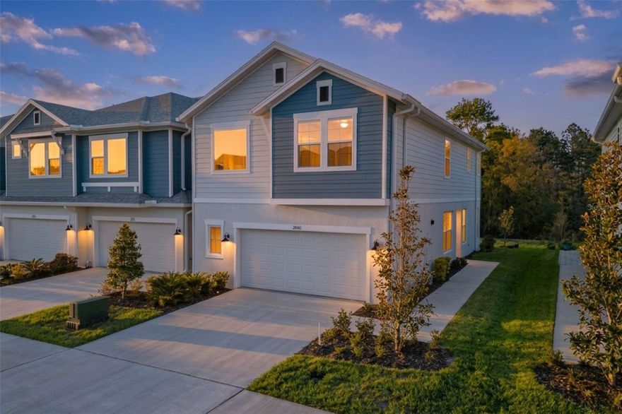 This rare end-unit David Weekley townhome in the award-winning Bexley community offers the spacious footprint and open feel of a single-family home with the low-maintenance lifestyle of a luxury townhome. Positioned on a scenic conservation lot with only one shared neighbor, this oversized floor plan stands out immediately with a unique side-entry foyer that creates a natural, open flow across the main level. To your left, a dedicated home office is tucked behind classic French doors which is perfect for remote work and conveniently located near the half bath and an expansive two-car garage that features extra width for a golf cart, workshop, or additional storage. The heart of the home is a bright, open-concept living area and chef’s kitchen featuring upgraded laminate flooring, quartz countertops, a large center island, and a premium gas cooktop with a wall oven and range hood. Natural light pours into the eat-in dining space which leads out to a rear patio overlooking peaceful green space. Upstairs, you are greeted by a versatile loft area that provides substantial extra living space rarely found in typical townhome layouts. This level also houses two additional bedrooms, a full bathroom, a laundry room, and the massive primary suite. This retreat features elegant tray ceilings and an ensuite bathroom that includes a garden tub, a large walk-in shower, and double sinks. Every inch of this home is built with the high-quality David Weekley style and attention to detail that truly makes it stand out from your typical townhome. Living in Bexley means enjoying resort-style amenities including miles of trails, multiple pools, a fitness center, and the community cafe while staying minutes from top-rated schools and the Suncoast Parkway. These specific units are a rare find on the market and are designed for buyers who want the space of a house without the exterior upkeep.