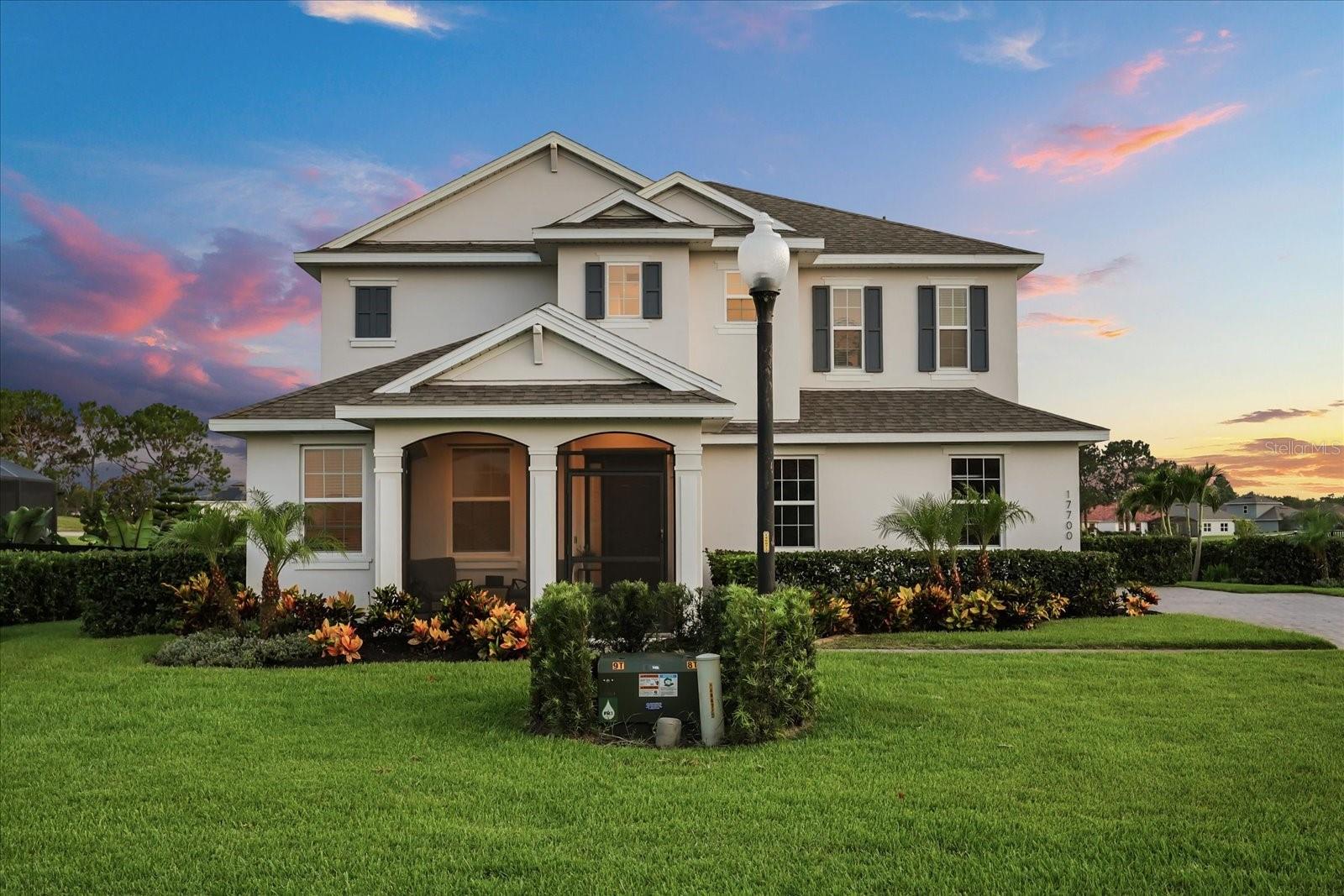Welcome to your dream residence in the prestigious Deer Island community—a 400-acre natural paradise renowned for its stunning landscapes, championship golf, and serene waterfront living. This impeccably crafted 2023-built home offers an exceptional blend of sophisticated design, smart home technology, and gorgeous water views from every room, overlooking tranquil golf course ponds and the sparkling expanse of Lake Dora. Step inside to discover an open-concept floor plan featuring 8' interior doors, seamlessly connecting the spacious living room, gourmet kitchen, and formal dining area. The living room, featuring beautiful laminate flooring and triple slider doors, invites abundant natural light and opens directly to the screened lanai and pool area, creating an effortless indoor-outdoor flow. The stunning kitchen features 42” custom wood cabinetry, quartz countertops, a farmhouse sink on a large island with bar seating, and premium stainless steel appliances including a built-in oven and microwave. Pendant lighting and Alexa-powered kitchen lights add a modern touch. Upstairs, the primary suite is a private sanctuary with two walk-in closets and a luxurious ensuite bathroom featuring a raised dual-sink vanity, a spacious walk-in shower with three shower heads, and a separate toilet room. Additional bedrooms provide ample space and walk-in closets, with a convenient Jack-and-Jill bathroom connecting two of the rooms. A versatile bonus room currently serves as a stylish office, perfect for remote work or study. Step outside to your private backyard retreat, where a saltwater pool with a black screen enclosure awaits. Imagine relaxing poolside as you watch the sun dip below the horizon, painting the sky with spectacular colors during unforgettable sunsets. The 20 x 8 screened lanai, complete with an 8-foot retractable shade awning and LED lighting, offers an ideal space for outdoor dining, entertaining, or simply unwinding while enjoying the gentle breeze and serene water views. The meticulously landscaped grounds feature paver patios and walkways, bordered flower beds, and a covered screened front porch, as well as a paver driveway and side-entry 2-car garage, enhancing the home’s curb appeal and outdoor living experience. Deer Island is more than a community—it’s a lifestyle. Enjoy access to a privately owned 18-hole championship golf course, recently ranked among America’s Top 50 Public Golf Courses and #5 in Florida. The community’s natural beauty, combined with modern amenities and unbeatable water views, makes this home a rare gem. Don’t miss the opportunity to experience this exceptional property and the unparalleled lifestyle Deer Island offers. Contact us today to schedule your private tour and see firsthand how this stunning home can elevate your living experience.