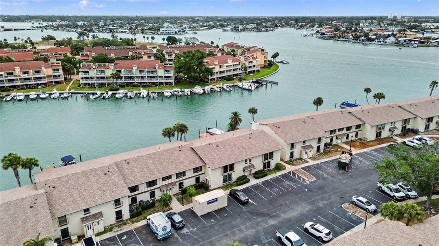 Completely renovated and move-in ready, this waterfront Treasure Island condo offers a rare combination of modern upgrades, timeless charm, and unbeatable proximity to the water. The brand-new kitchen features all-new lower cabinets, new appliances that have never been used, a new sink, and a stylish new backsplash, with matching new countertops carried into both beautifully updated bathrooms. Additional improvements include a brand-new tankless water heater, brand-new air handler and compressor, all new hurricane-rated windows, and two oversized hurricane-rated sliding doors that fill the home with natural light. The entire electrical system has been updated as well, including all new outlets and a new fuse panel. Ceramic tile flooring flows through the main living areas and bathrooms, while both bedrooms feature laminate flooring for added warmth. This unit is also one of the few in the entire community with a working fireplace, adding a unique and cozy focal point. The primary suite includes a grandfathered-in washer and dryer closet with hookups—an amenity most units do not have, as the majority must use the community laundry facilities. Outside, the seawall has been completely rebuilt and raised approximately three feet, offering added protection and peace of mind. Enjoy serene waterfront living with a community dock just about 30 feet from your rear patio, perfect for relaxing, dolphin watching, or taking in the sunset. The community pool is only a short stroll away and sits right on the water, surrounded by outdoor gathering areas with grills and shaded seating. Lovingly owned by the previous owners for 53 years and now fully modernized, this exceptional home stands out as one of the most updated and desirable units in Plaza Seville.