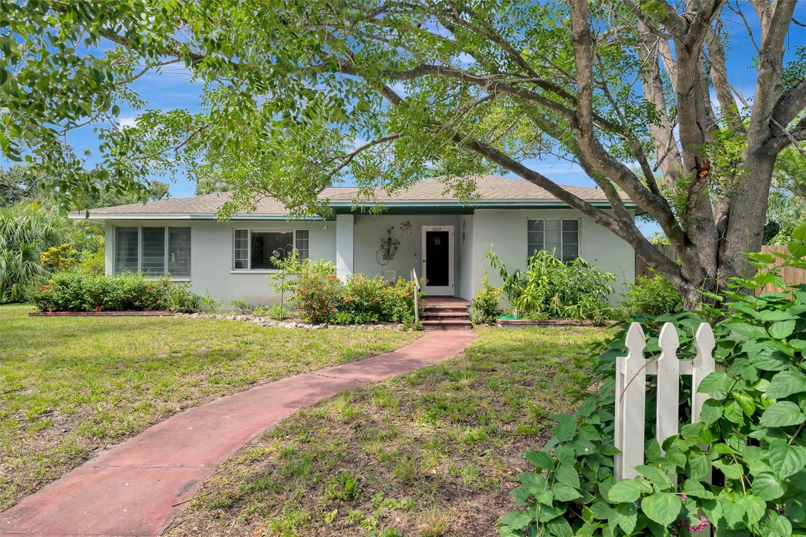 Step into charm and opportunity with this 3-bedroom, 2-bath home situated on a fenced corner lot of more than one-third acre. The front of the home offers 2 bedrooms and 1 bath, while the back provides a private 1 bedroom and 1 bath—perfect for extended family, guests, or flexible living. Inside, you’ll find original hardwood floors, spacious open living areas, and a versatile flex room ideal for a studio, yoga, art, or fitness space.
Updates include a roof (2015), water heater (2023), electrical panel (2020), full plumbing re-pipe (2015), HVAC (2006), and a transferable home warranty through April 2027. Additional features include a 2-car garage, screened side lanai with private entry, and plenty of outdoor space for RVs, boats, or trailers. Time to schedule your personal showing and pick out a new exterior paint color to make this home your own.
Unique BR_T-4R zoning allows a wide variety of uses—including the potential to run a business or add a detached dwelling unit (buyer to verify with Manatee County). With no HOA or CDD fees, this vintage home offers both character and freedom to create your vision. Conveniently located near Anna Maria Island beaches, downtown Bradenton dining and shopping, Sarasota/Bradenton Airport, hospitals, and public golf courses.