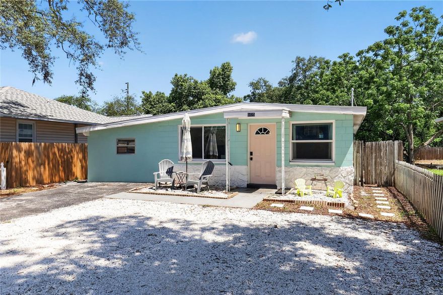Welcome to this charming and versatile BLOCK home tucked just minutes from the heart of Gulfport! From the moment you arrive, the sunny front yard and welcoming curb appeal set the tone for the relaxed Florida lifestyle this property offers.

Step inside to an open and airy living, dining, and kitchen space where natural light pours in, creating a warm and inviting atmosphere perfect for gathering with family or entertaining friends. The beautifully updated kitchen features gorgeous granite countertops, real wood cabinetry, stainless steel appliances, and bright modern lighting that makes the entire space feel fresh and functional.

Down the hall, you’ll find three generously sized bedrooms, a shared hall bathroom with a durable solid-surface tub surround designed to resist mold and mildew, and a full laundry room that adds everyday convenience and extra storage space.

What truly makes this property special is the attached private studio apartment with its own separate entrance located on the left side of the home. Whether you’re looking for a guest suite, multigenerational living setup, income-producing opportunity, private office, or creative space, this flexible studio opens the door to endless possibilities. Inside, you’ll find a spacious open layout, a charming kitchenette with a sleek flat glass cooktop built directly into the countertop, a private bathroom, and even a stackable washer and dryer tucked neatly into the closet for complete independence and convenience.

Out back, the fully fenced yard is already set up for enjoying life outdoors. With alley access, a fire pit area, picnic space, and plenty of room to personalize, it’s easy to imagine cozy evenings under the lights, weekend get-togethers, or simply unwinding after a day at the beach. There’s still plenty of room to create your own backyard oasis.

Perfectly located near the waterfront charm and local restaurants of Gulfport, the nightlife and energy of Downtown St. Petersburg, the sandy shores of St. Pete Beach, and convenient commuting routes throughout Tampa Bay, this home offers the flexibility, character, and location that make Florida living so special.